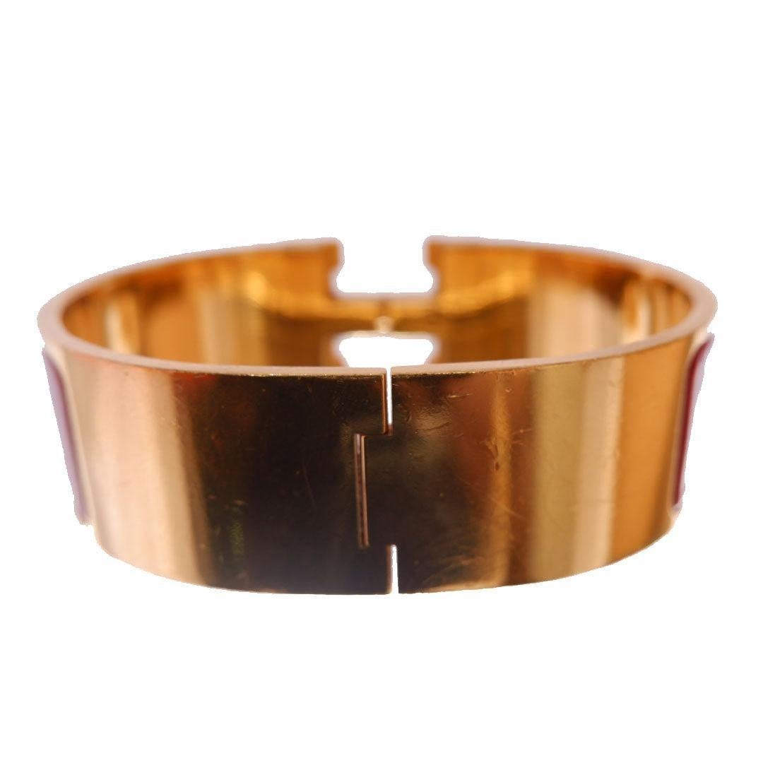 Hermes Clic Clac Wide bangle bracelet in red metal with gold-tone hardware and signature H turn-lock closure.
 

110409MSC
