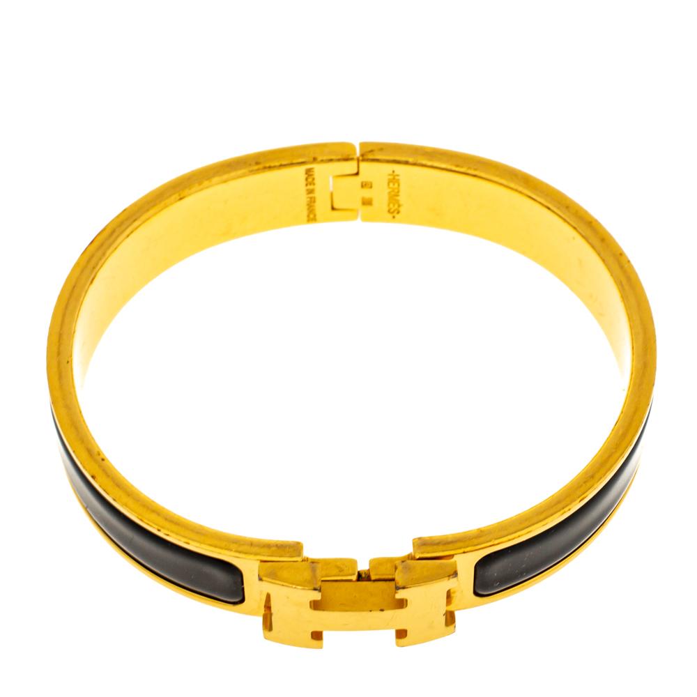 This bracelet embodies Hermès’ elegant craftsmanship with its gold-plated metal body coated with black enamel. Featuring the brand's iconic 'H' at the front, this bracelet is the ultimate accessory to buy today!

