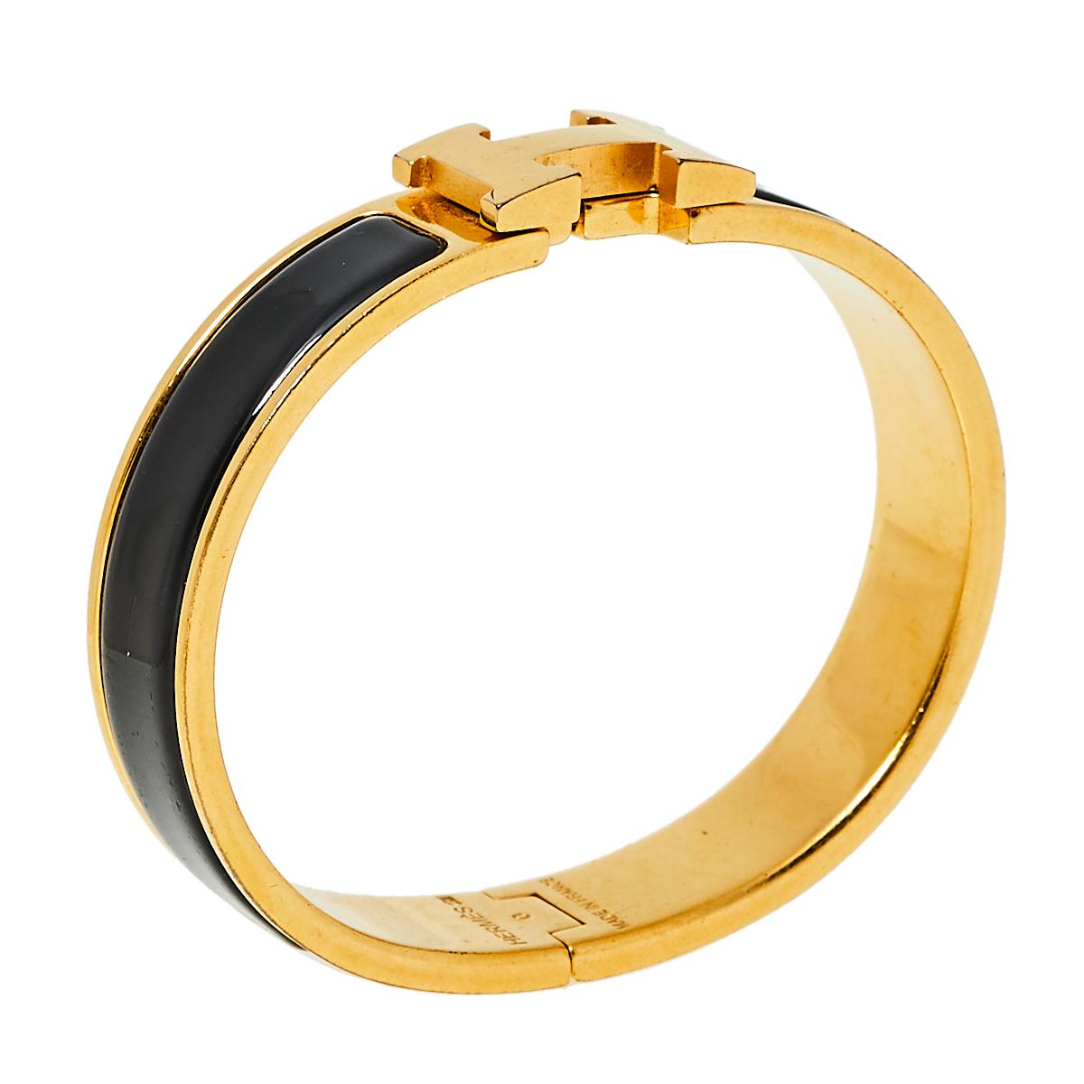 This Clic H bracelet embodies Hermès’ elegant craftsmanship with its gold-plated metal body and black enamel inlay. Featuring the iconic H logo of the fashion house at the front, this bracelet is the accessory to buy today!

