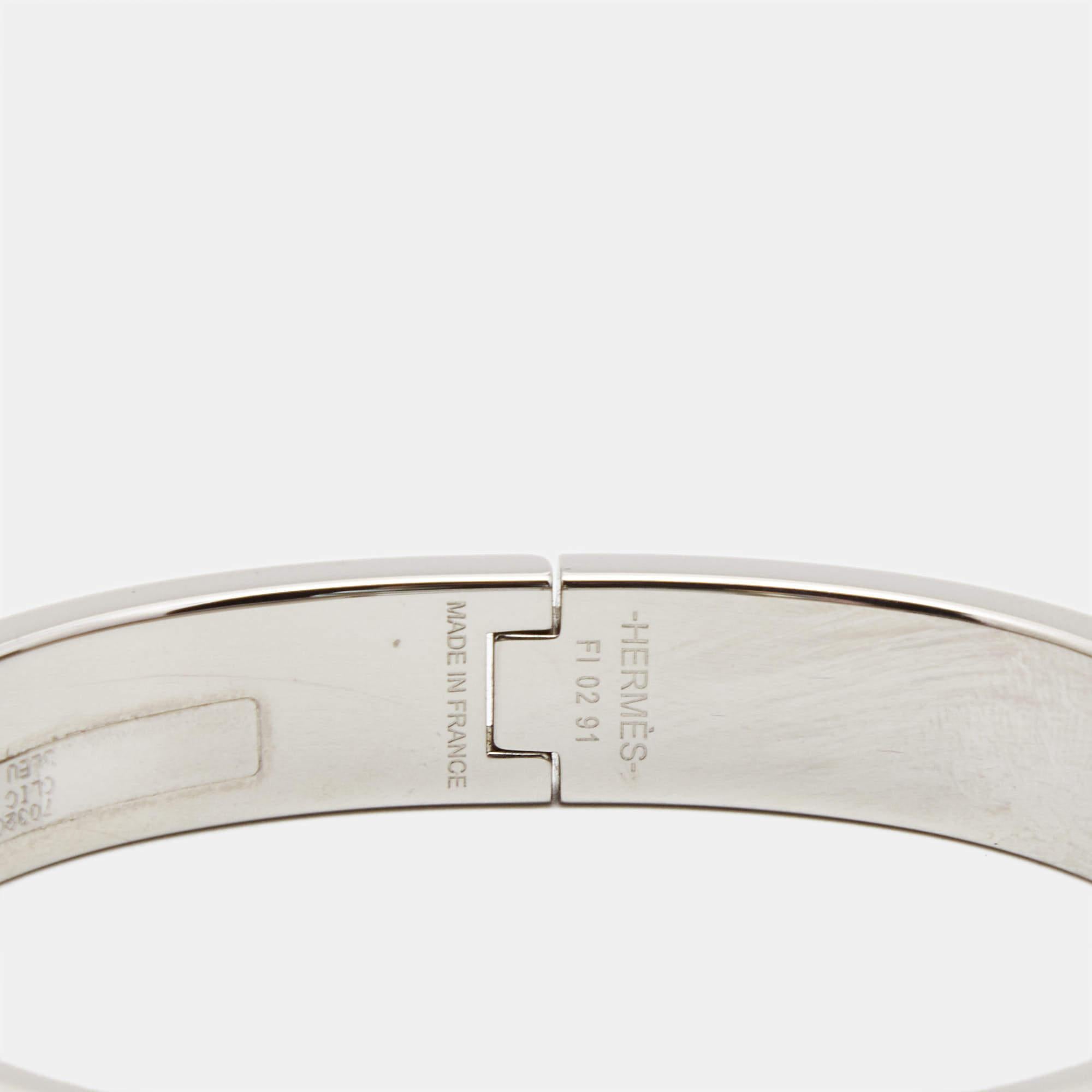Adorn your wrist with this stunner of a bracelet from Hermes. The piece is from their Clic H collection, and it has been crafted from palladium-plated metal and designed with blue enamel. This bracelet is complete with the iconic H to the front. Get