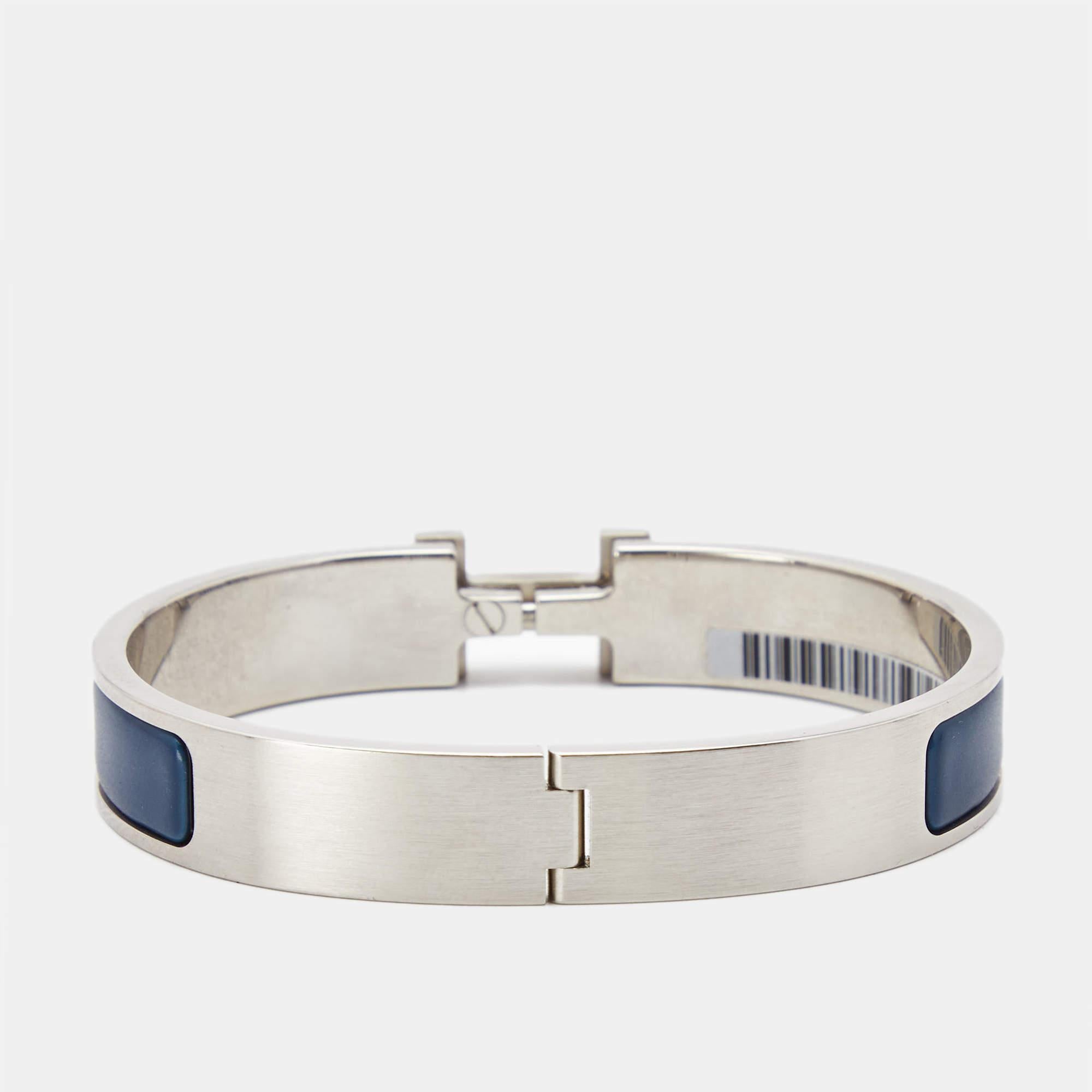 Adorn your wrist with this stunner of a bracelet from Hermes. The piece is from their Clic H collection, and it has been crafted from palladium-plated metal and designed with blue enamel. This bracelet is complete with the iconic H to the front. Get