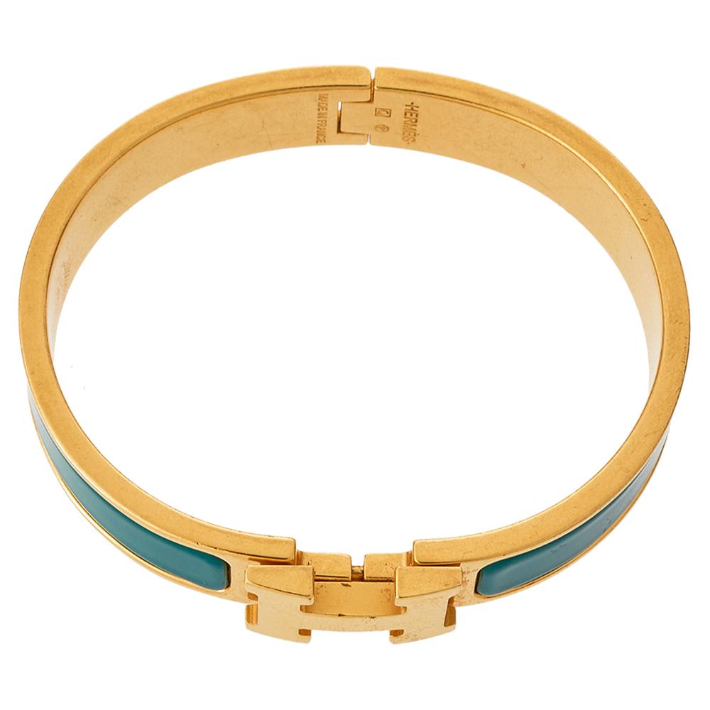 Adorn your wrist with this stunner of a bracelet from Hermes. The piece is from their Clic H collection, and it has been crafted from gold-plated metal and designed with green enamel. This bracelet is complete with the iconic H to the front. Get