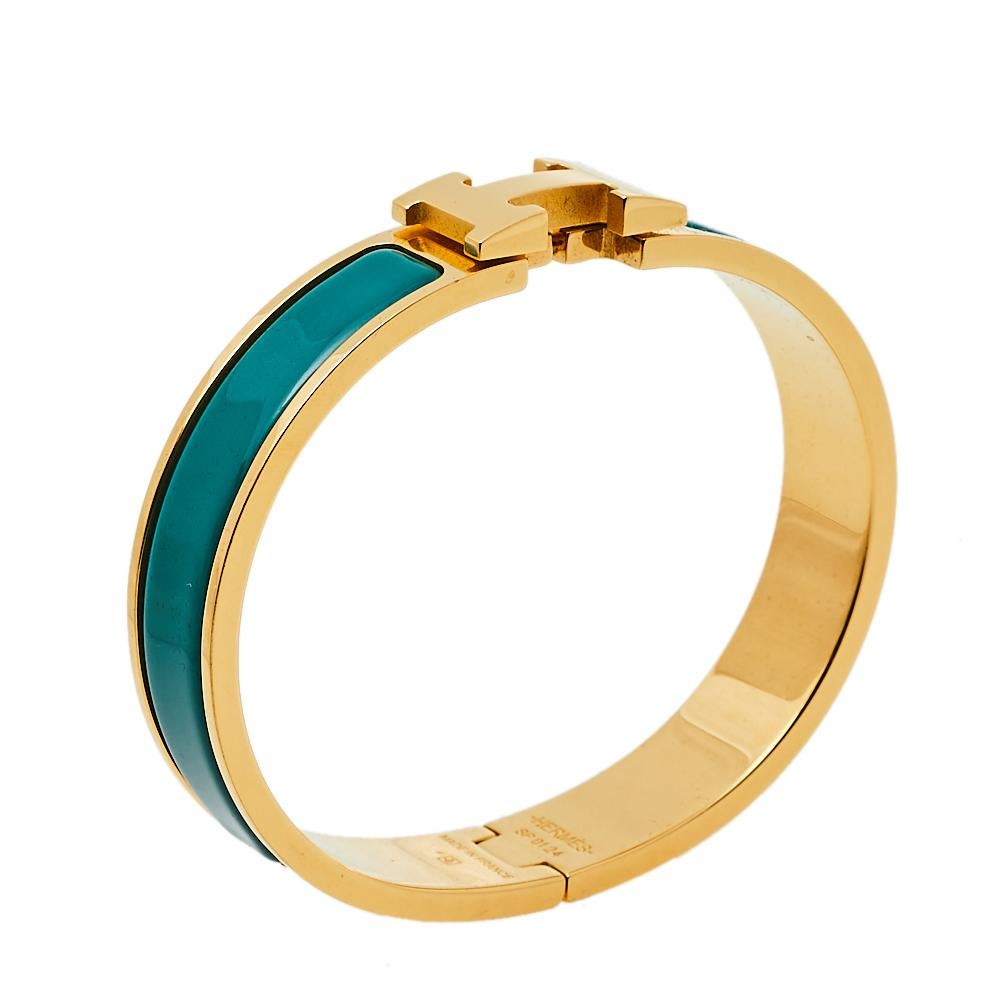 Adorn your wrist with this stunner of a bracelet from Hermes. The piece is from their Clic H collection, and it has been crafted from gold-plated metal and designed with green enamel. This bracelet is complete with the iconic H to the