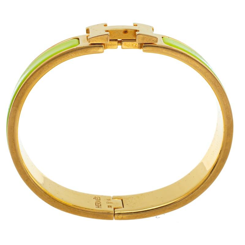 Ace the accessory game with this stunner of a bracelet from Hermès. The piece is from their Clic H collection and it has been crafted from gold-plated metal and designed with lime green enamel. This bracelet is complete with the iconic H at the