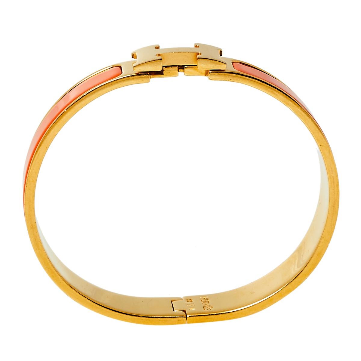 This Clic H bracelet embodies Hermès’ elegant craftsmanship with its gold-plated metal body and orange enamel inlay. Featuring the iconic H logo of the fashion house at the front, this bracelet is the accessory to buy today!

