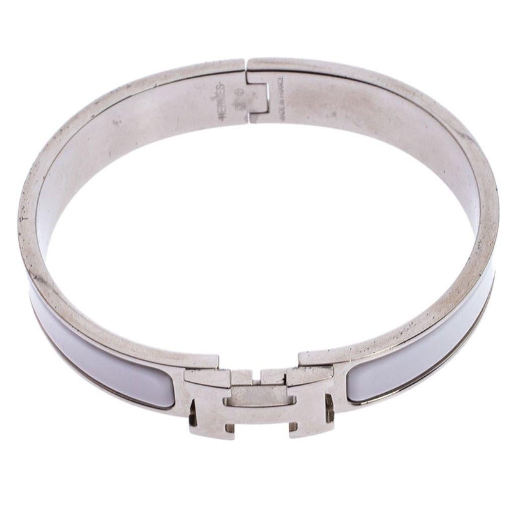 Ace the accessory game when you adorn your wrist with this stunner of a bracelet from Hermes. The piece is from their Clic H collection and it has been crafted from palladium-plated metal and designed with white enamel. This bracelet is complete
