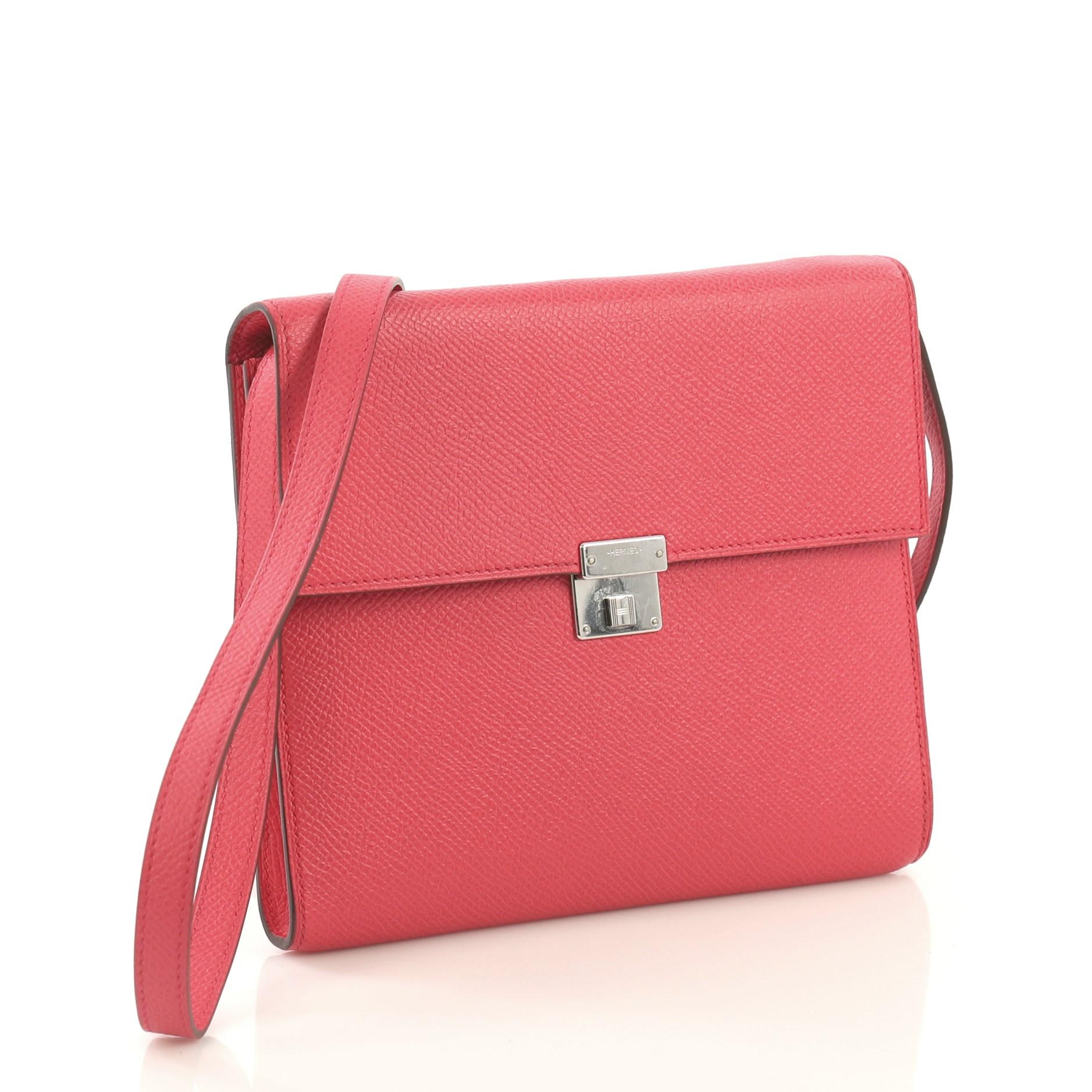 This Hermes Clic Wallet on Strap Epsom 16, crafted in Rose Extreme pink Epsom leather, features long leather strap, frontal flap and palladium hardware. It clasp closure opens to a Rose Extreme pink Epsom leather interior with multiple card slots
