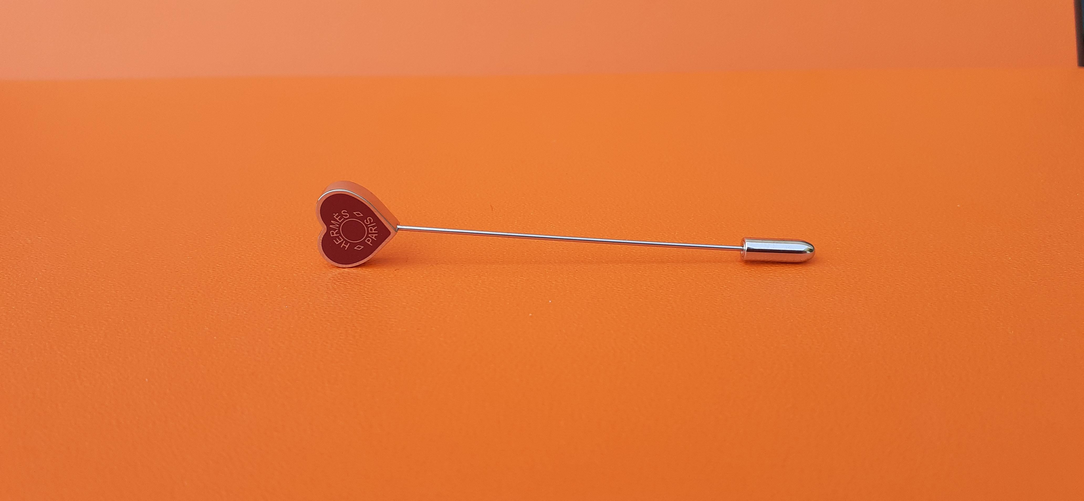 Cute Authentic Hermès Pin

Heart-shaped Clou de selle

Can be used as pin, brooch, wherever you want

Made in France

Made of lacquered palladium plated metal with and stainless steel pin

Colorways: Burgundy, Silver-Tone

Measurements: 
- Total