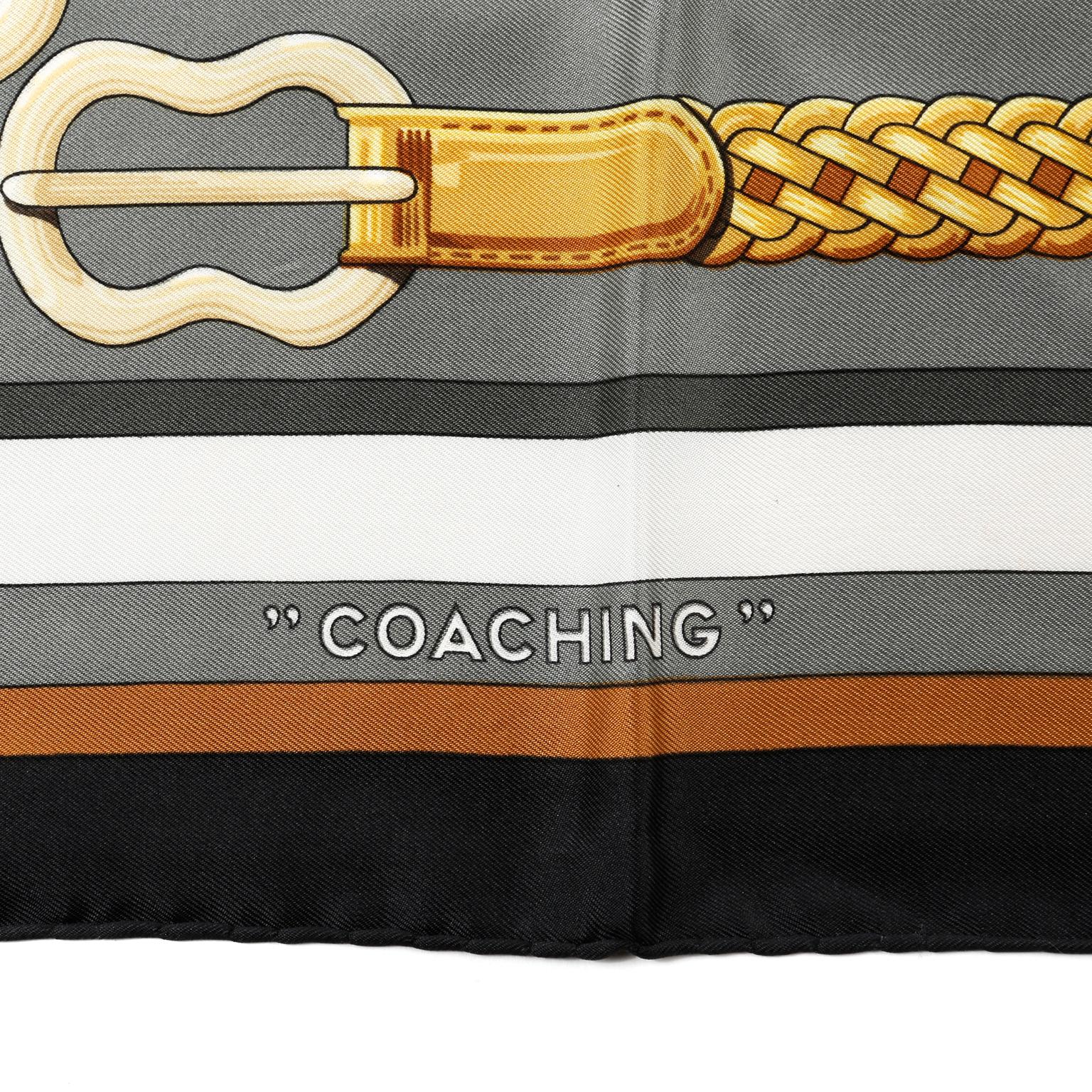 This authentic Hermès Coaching 90 cm Silk Scarf is in pristine condition.   Designed by Julie Abedie, this is a reissue of the original 1977 design.  Equestrian theme featuring belts, harnesses, and straps.  Creamy white background with black