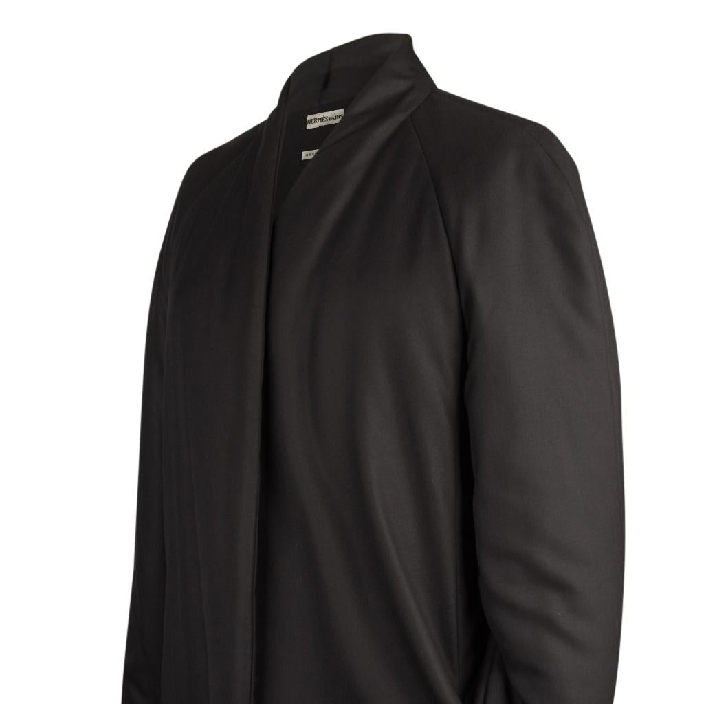 Guaranteed authentic Hermes  remarkably warm black weightless cashmere coat. 
Beautifully styled with a straight cut, subtle stitching detail on the side, and gentle wadding throughout.
Open front.
The coat has a detachable wadded shawl with a