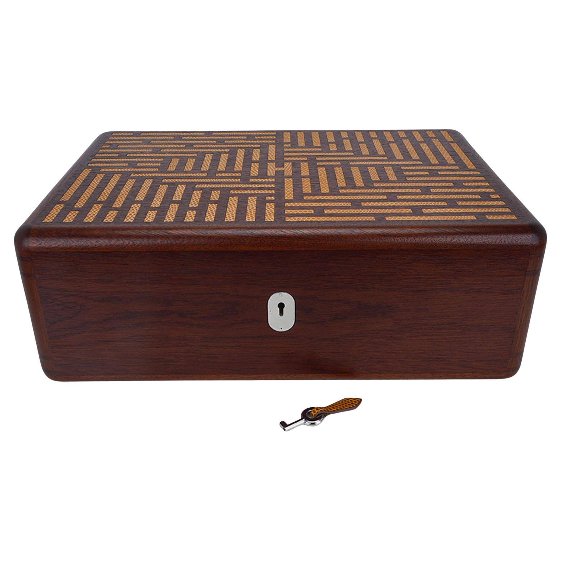 Mightychic offers an Hermes Coffret a Cigares Humidor cigar storage box.
Featured in Sycamore wood with inlaid lizard in Sesame.
Inlays form 