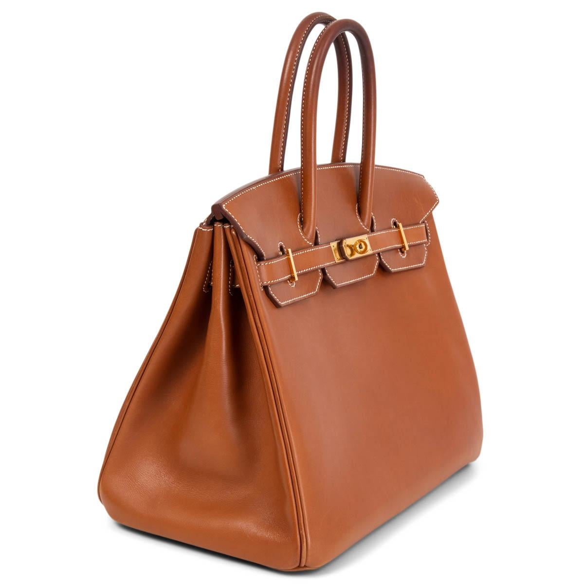 100% authentic Hermès 'Birkin 35' bag in Fauve (cognac brown) Barenia leather with contrasting white stitching and gold-plated hardware. Rare chance to get your hands on the coveted Barenia Birkin - this leather will developed a beautiful patina