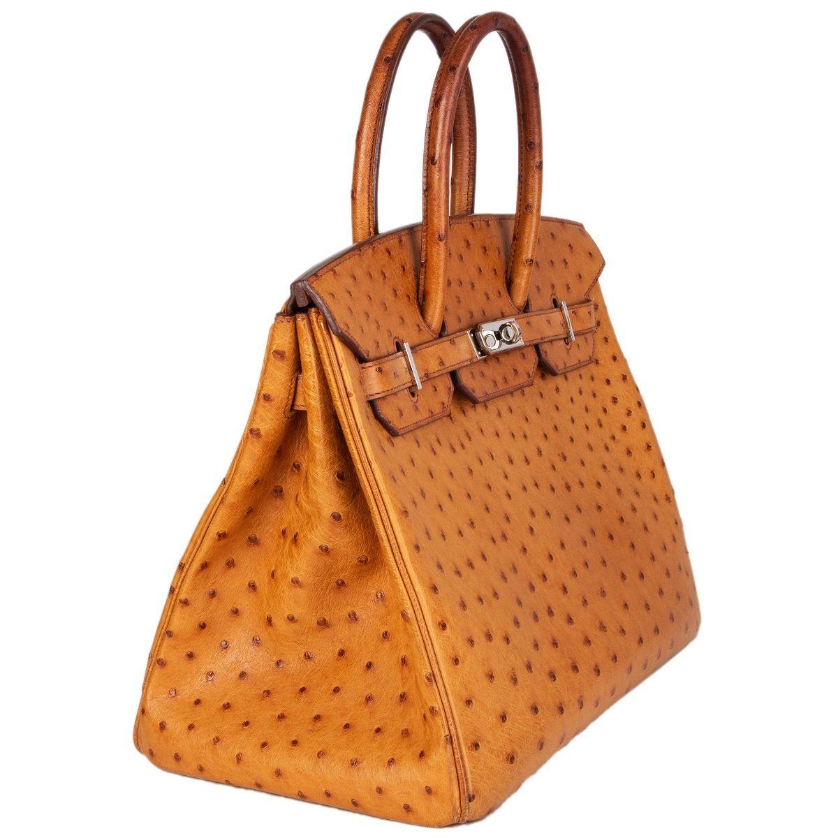 Hermès 'Birkin 35' bag in Cognac ostrich leather. Lined in Chevre (goat skin) with an open pocket against the front and a zipper pocket against the back. Has been carried with heavy darkening to the handles and soft wear to the bottom corners.