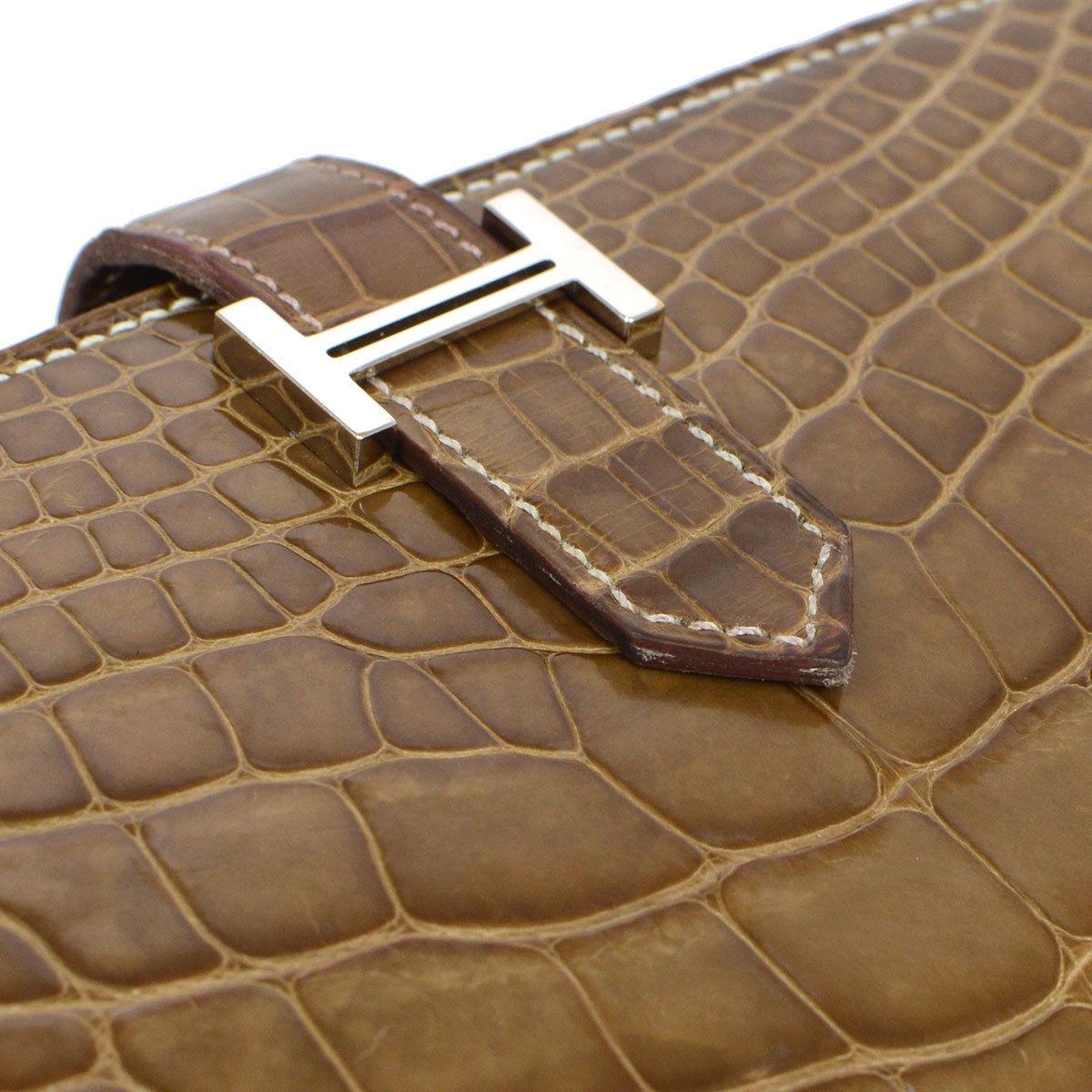 Hermes Cognac Chocolate Crocodile Palladium Evening Clutch Wallet Bag in Box

Alligator 
Palladium hardware
Fold in buckle closure
Leather lining
Date code present
Made in France
Features zip closure, bill compartment and card slots 
Measures 7