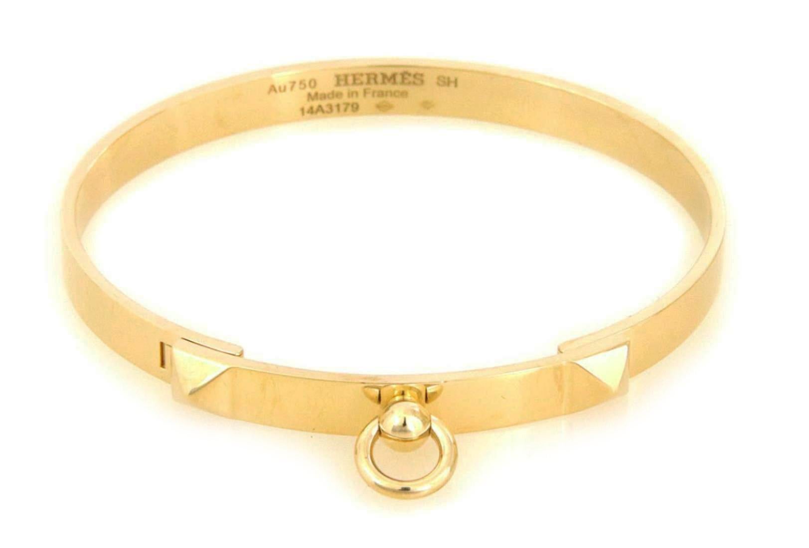 Chic and authentic by Hermes from the Collier de Chien Collection. This elegant bangle is crafted from 18k yellow gold in a high polished finish featuring a long 6mm wide bar across the front decorated with a pyramid shape on each end of the bar.