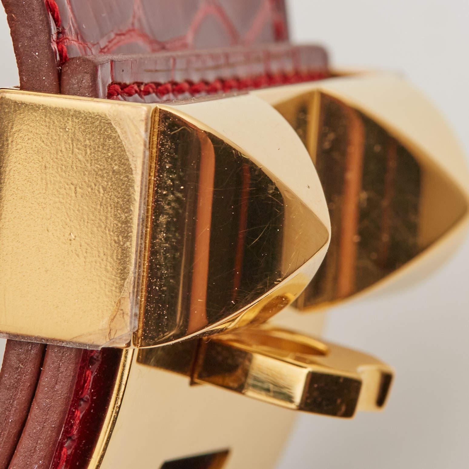 Embrace opulent sophistication with the Hermès Collier de Chien bracelet. Crafted with sumptuous alligator leather and adorned with gleaming gold-plated hardware, it exudes timeless elegance, making it a coveted statement piece for the discerning