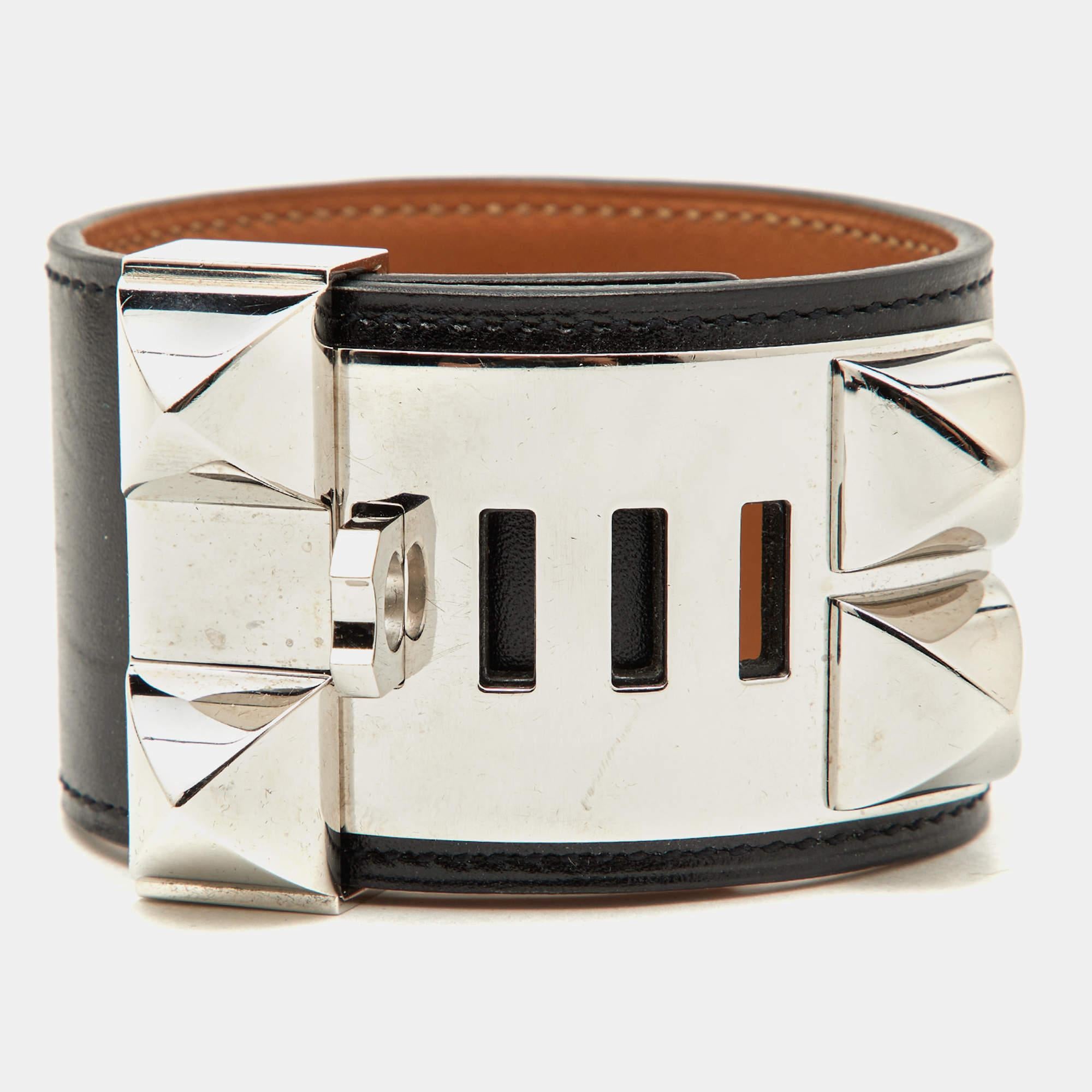 This instantly recognizable bracelet is from the signature Collier de Chien collection by Hermès. The bracelet, made of black leather, is adorned with the iconic Collier de Chien motif in palladium-plated metal involving pyramid studs and a ring. It