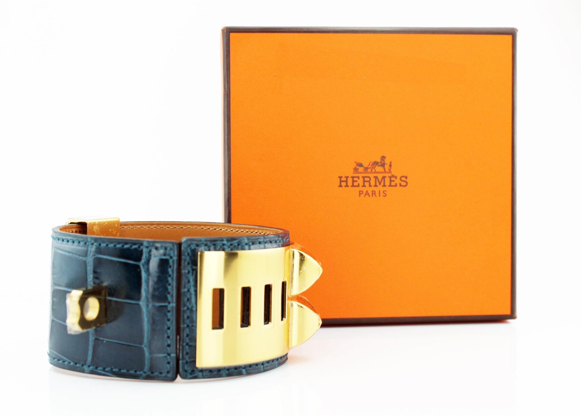 Hermes Collier De Chien Crocodile Cuff
Blue crocodile cuff with gold plated pyramid studs and ring.
New with stickers.
Original pouch and box
Size: Small
RRP £1,700