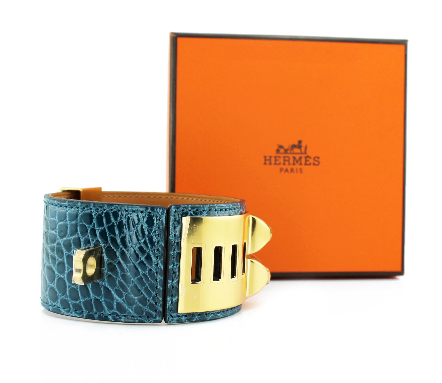 Hermes Collier De Chien Crocodile Cuff
Blue crocodile cuff with gold plated pyramid studs and ring
New with stickers.
Original pouch and box
Size: Small
RRP £1,700