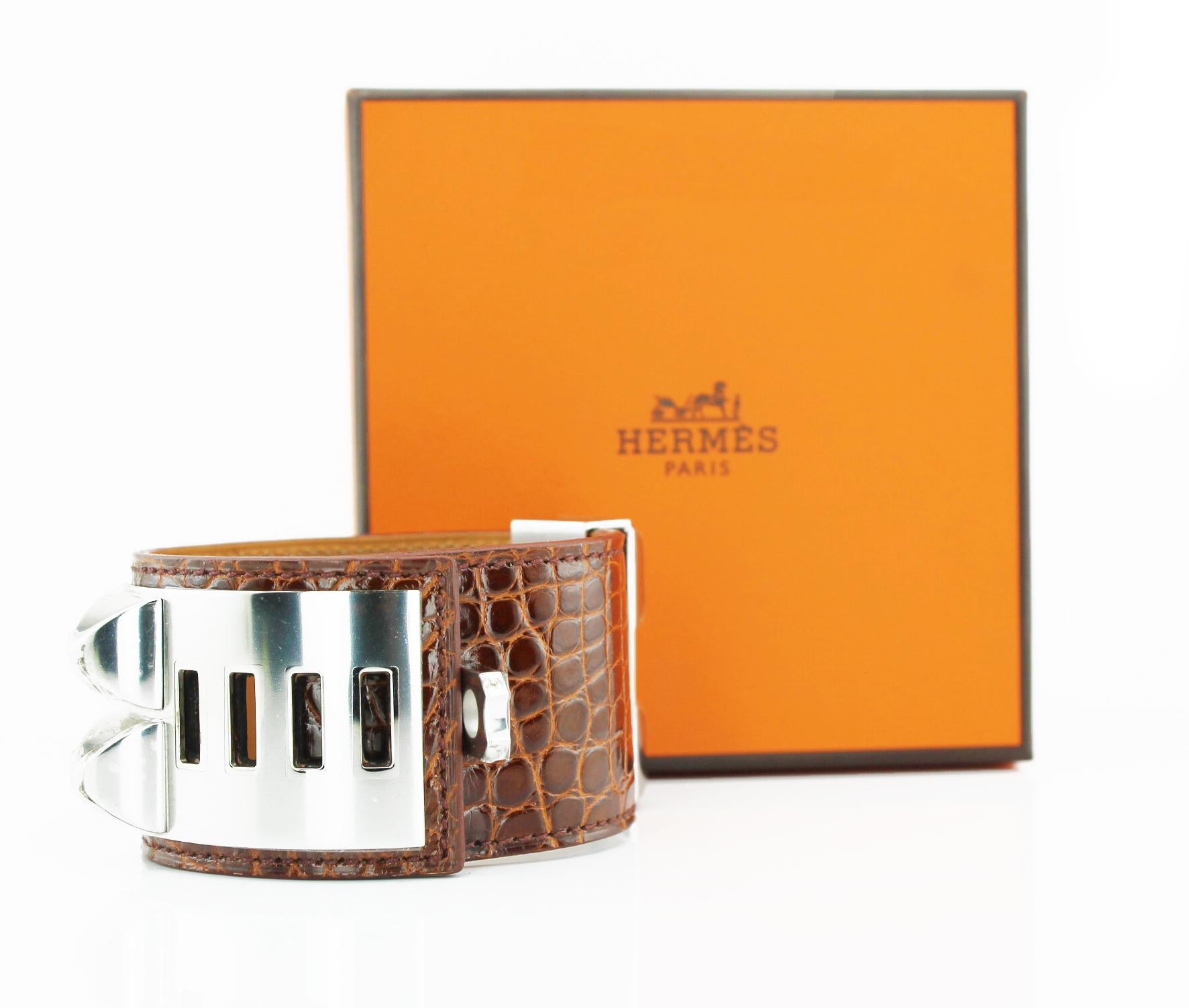 Hermes Collier De Chien Crocodile Cuff
Brown crocodile cuff with palladium pyramid studs and ring
New with stickers.
Original pouch and box
Size: Small
RRP £1,700