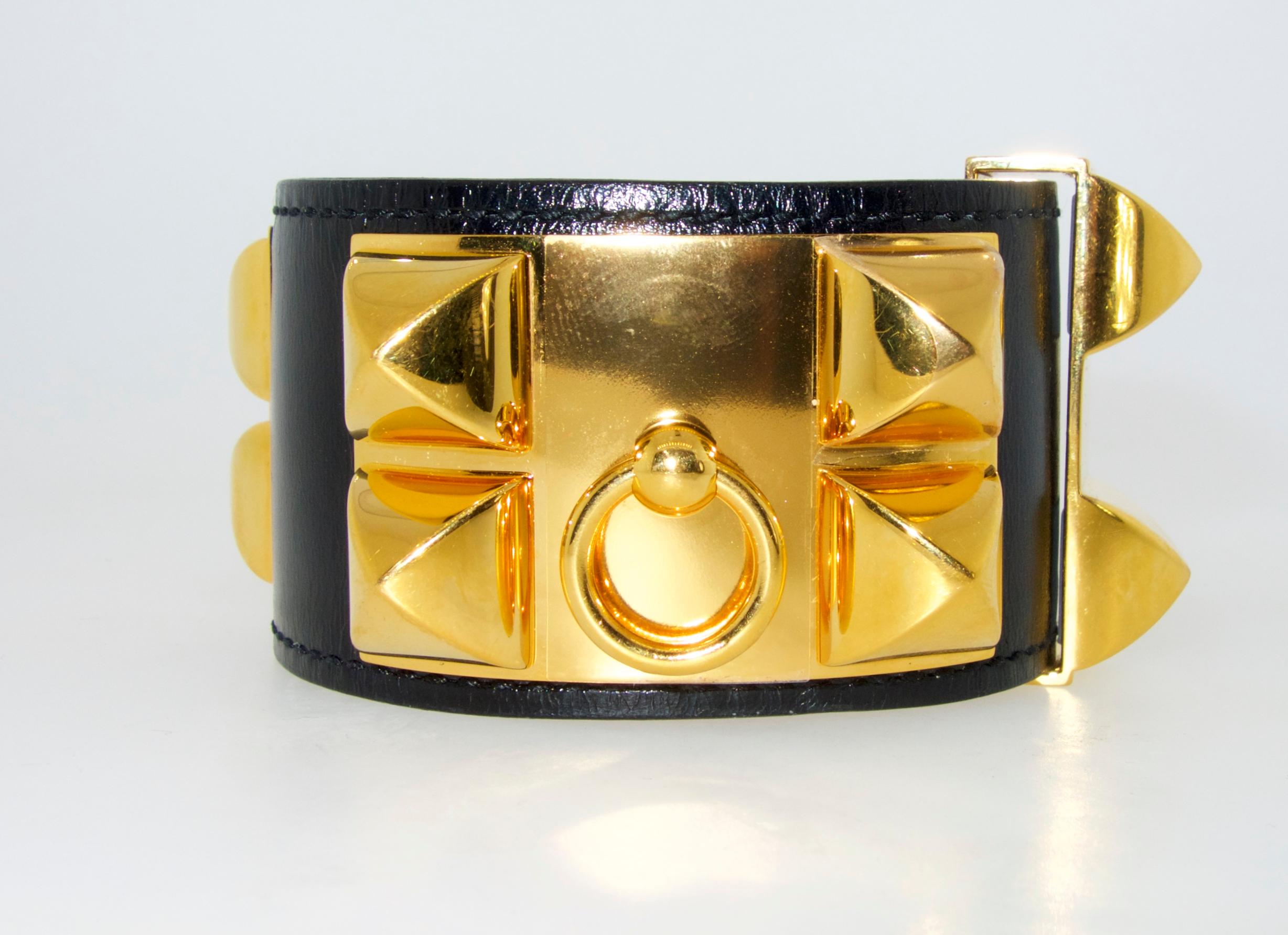 This classic Hermes piece is in new like condition with the Hermes box.  The fine unused leather is black.  Note that the bracelet can be worn at different lengths so this piece will fit most any wrist size.  2.25 by 2 inches.  This well made piece