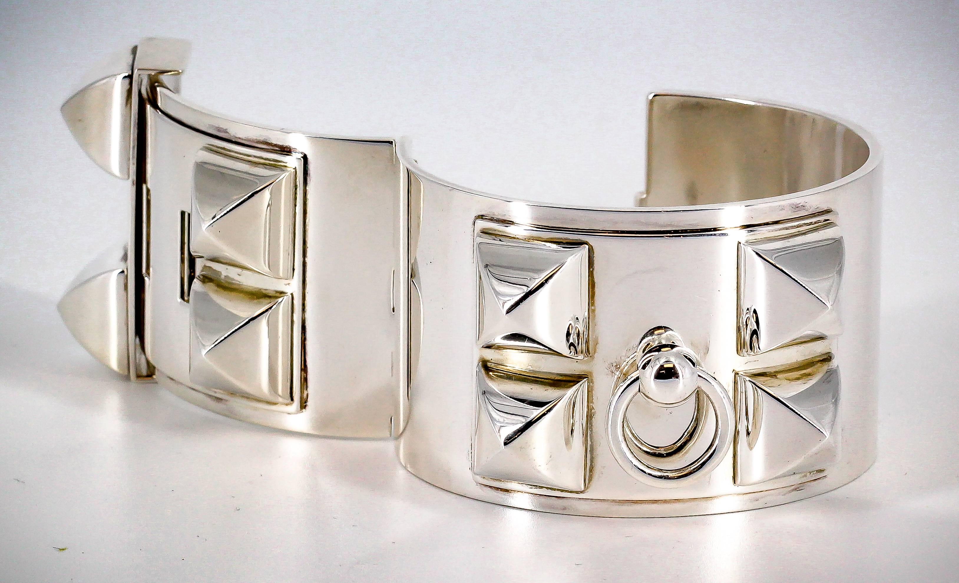 Bold sterling silver studded cuff bracelet from the Collier de Chien collections by Hermes. It features a smooth finish with large studs and easy closure. This is the large version they offer.

Hallmarks: Hermes, AG925, Made in Germany, A * G, LG.