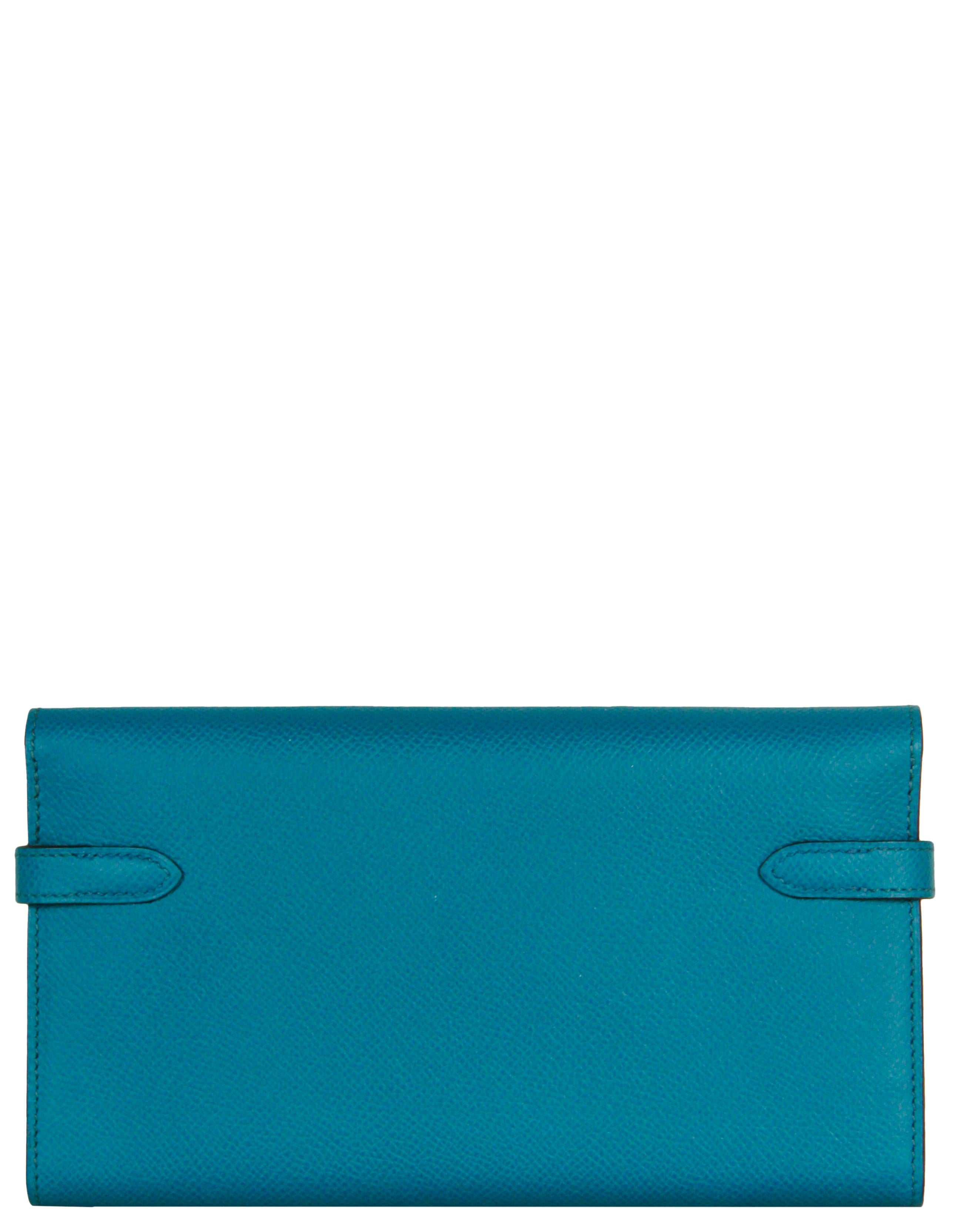Hermes Blue Leather Kelly Longue Wallet w/ Palladium

Made In: France
Year of Production: 2014
Color: Colvert blue
Hardware: Silvertone palladium
Materials: Epsom leather
Lining: leather
Closure/Opening: Double arm strap with twist lock
Interior