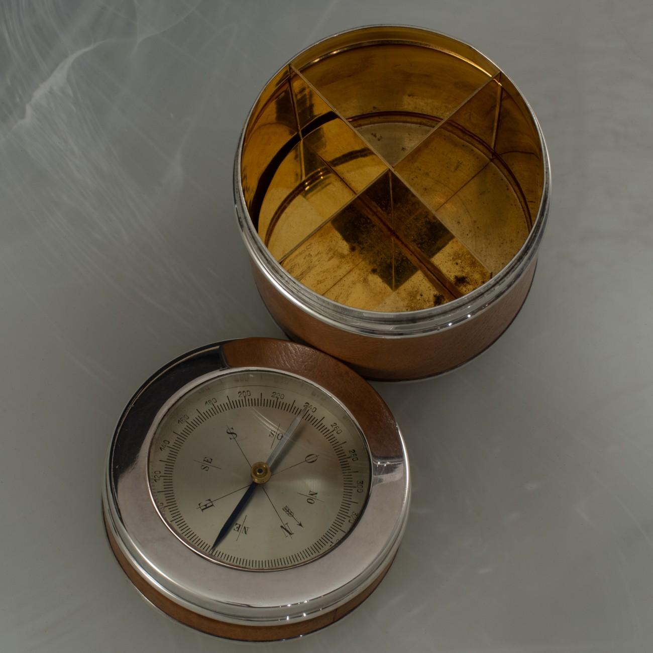 Stylish Hermès pigskin and silver plated pot with compass in the lid and gilded interior, originally designed to hold cigarettes, circa 1930 and fully marked on the base. With a typically stylish detail; the steel compass needle is blued on the