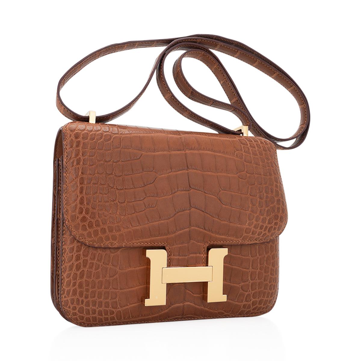 Mightychic offers an Hermes 1-18 Constance bag featured in Gold Matte Alligator.
Removeable mirror with alligator tab. 
Rich with Gold hardware.
The effect is understated chic.
Hermes Paris Made in France is stamped on front under flap.
Comes with