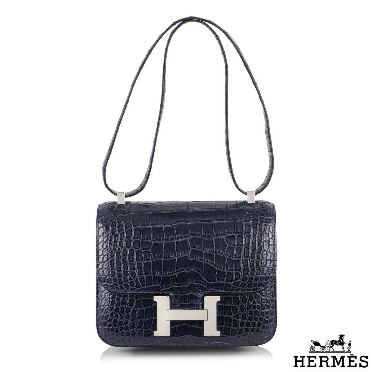 An exquisite Hermès Blue Marine Constance 24 cm of exotic matte Mississippi Alligator leather with palladium hardware. Prized for its durability, this Matte Alligator will get more beautiful with age, developing its coveted satiny shine. The