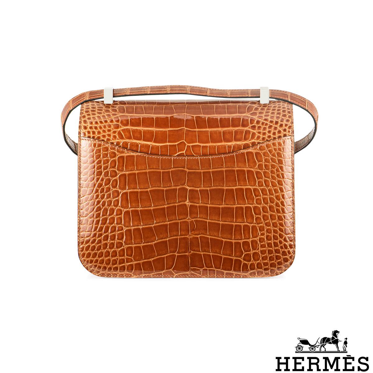 A rare and exceptional Hermès Constance 24cm Mississippiensis Alligator handbag. This exotic bag is adorned with a Lisse Mississippi Alligator in Cuivre complemented by palladium hardware. The exterior of this Constance features tonal stitchings, an