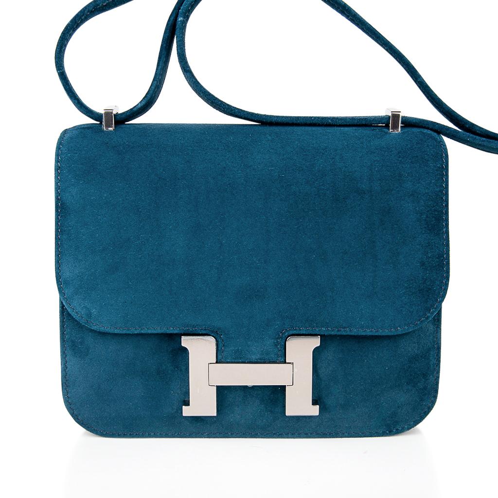 Guaranteed authentic exquisite limited edition Hermes coveted Doblis (suede) bag features the Constance Mini in Blue Ocean.
Beautiful muted Blue with sutble green undertone that is neutral and perfect for year round wear.
This is a highly