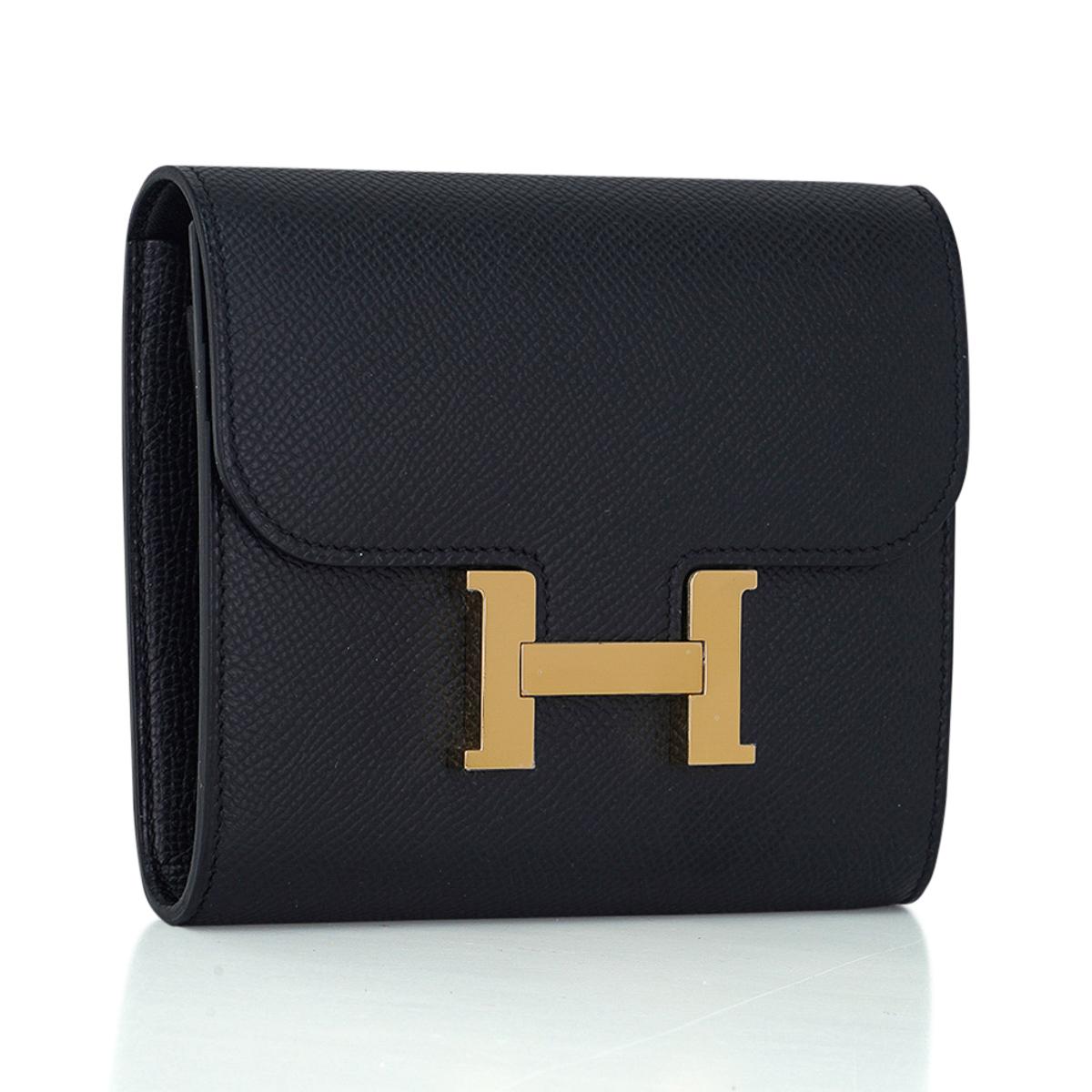 Mightychic offers an Hermes Constance Compact Wallet featured in Noir.
This classic wallet features 4 credit card slots, 1 zip compartment and 1 rear slot.
Epsom leather has fine grain and saturates colour to its richest hue.
Rich with Gold