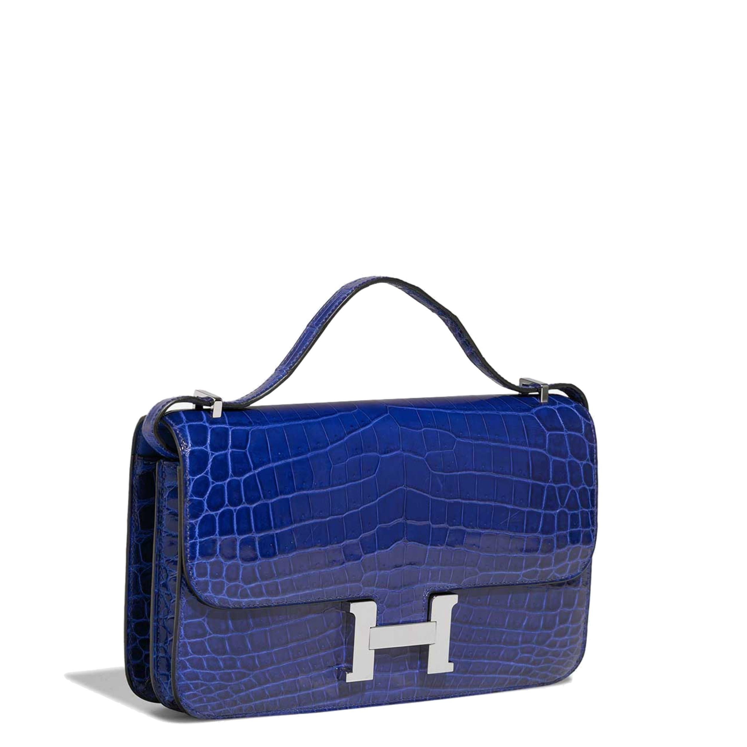 This 25cm Constance Elan shoulder bag from Hermès was meticulously crafted in France from a highly precious exotic in an electric shade of blue. Offset with silver-tone palladium-plated hardware, its slender body is adorned with the brand's