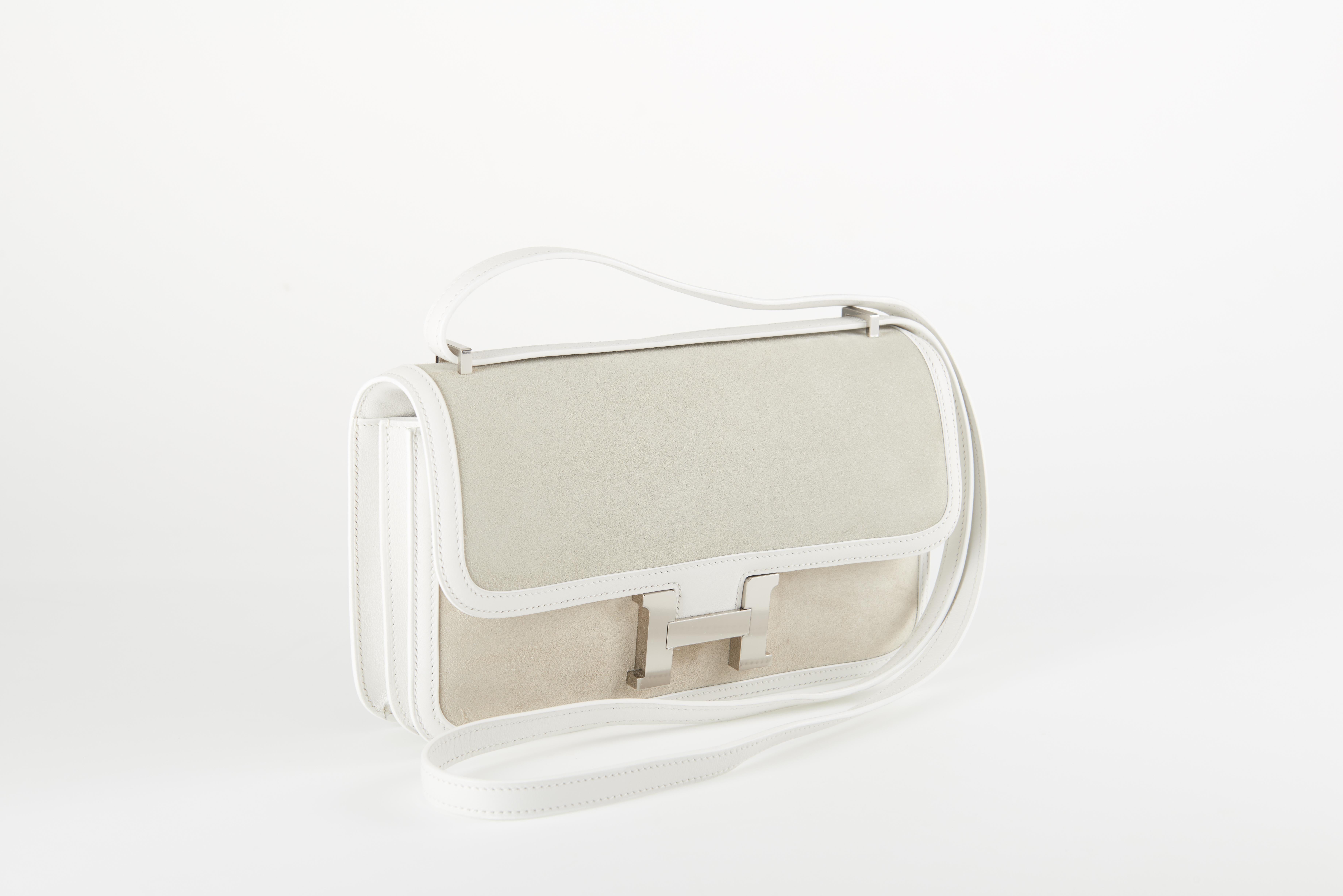 Discontinued Hermes Constance Elan in white swift leather with galet suede insets and palladium hardware. 

Original packaging. 

