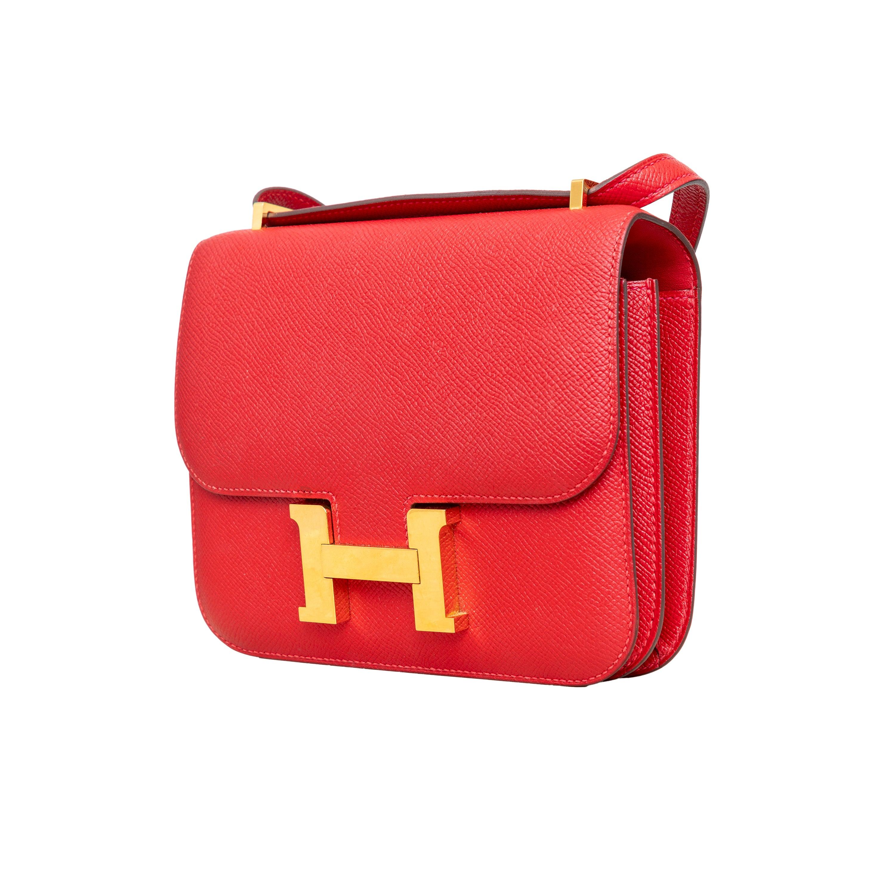 Carry elegance and functionality with the stunning Hermès Constance III Mini Bag. Its red epsom leather exterior is accented with golden hardware inserts, while the convertible shoulder strap allows for versatile wearing options. The iconic 