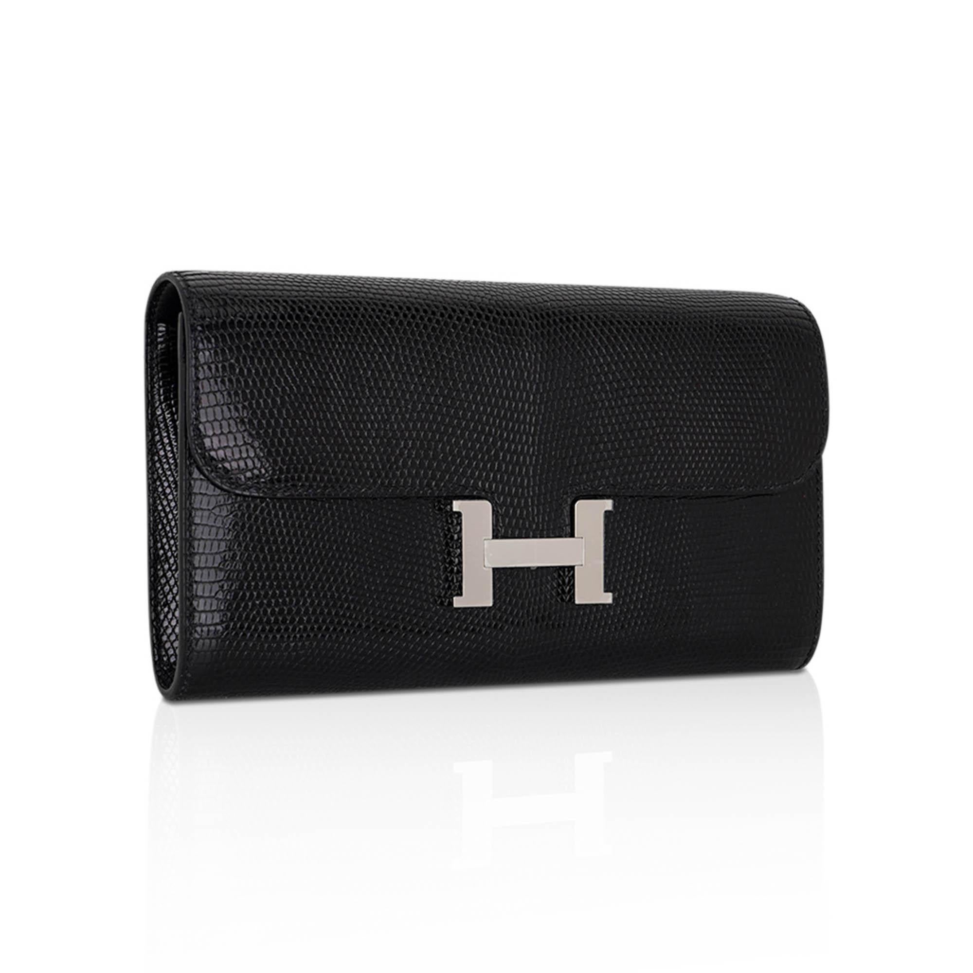 Mightychic offers an Hermes Constance to go wallet in strikingly rich Black Lizard.
Crisp with palladium hardware.
The consummate Wallet on a Chain!
Detachable strap allows you to carry the wallet / bag as a clutch.
Classic Constance push lock with