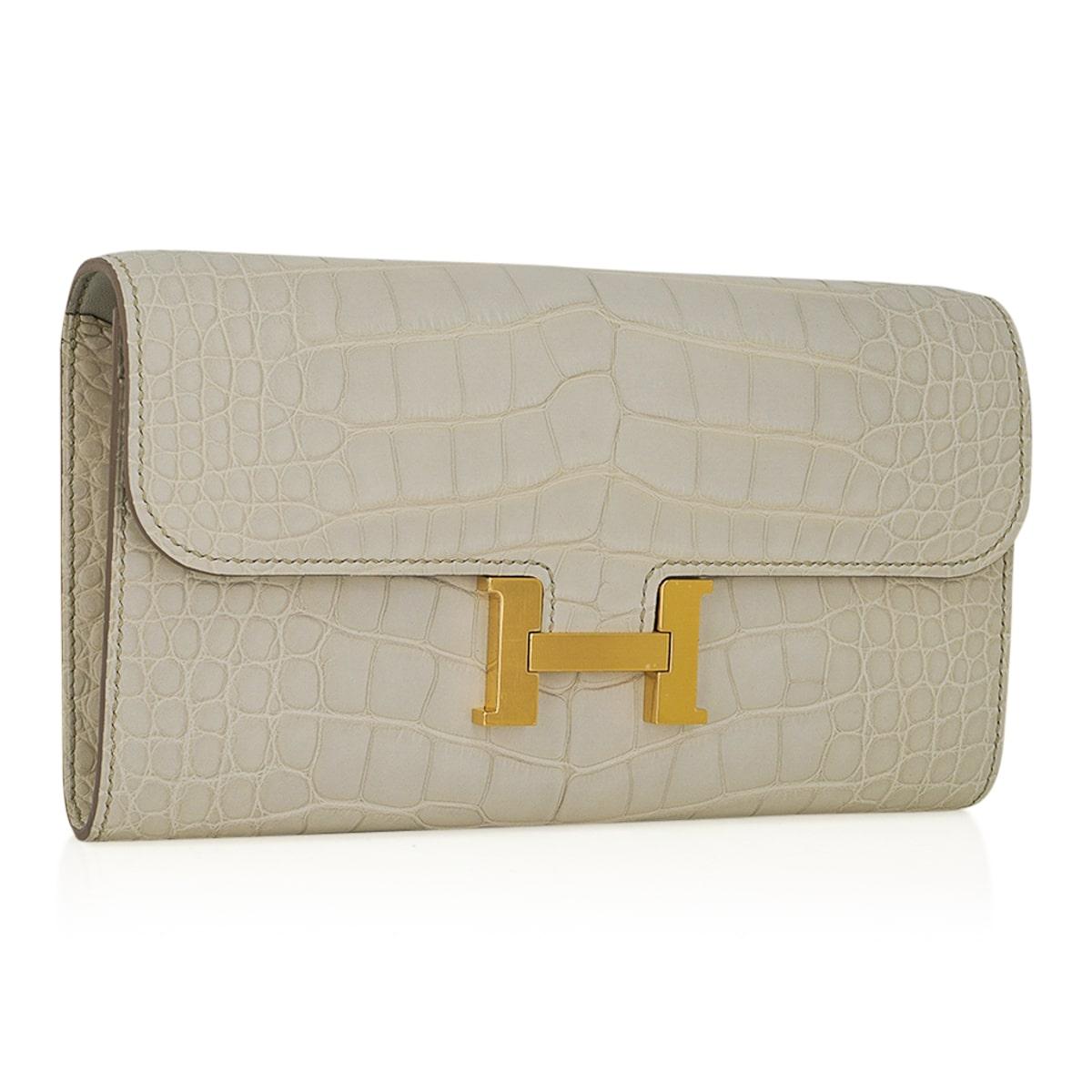 Mightychic offers an Hermes Constance LongTo Go Wallet featured in coveted Beton Matte Alligator.
This stunning neutral Constance To Go is accentuated with Gold hardware.
Detachable crossbody / shoulder strap converts this gorgeous Constance Long To