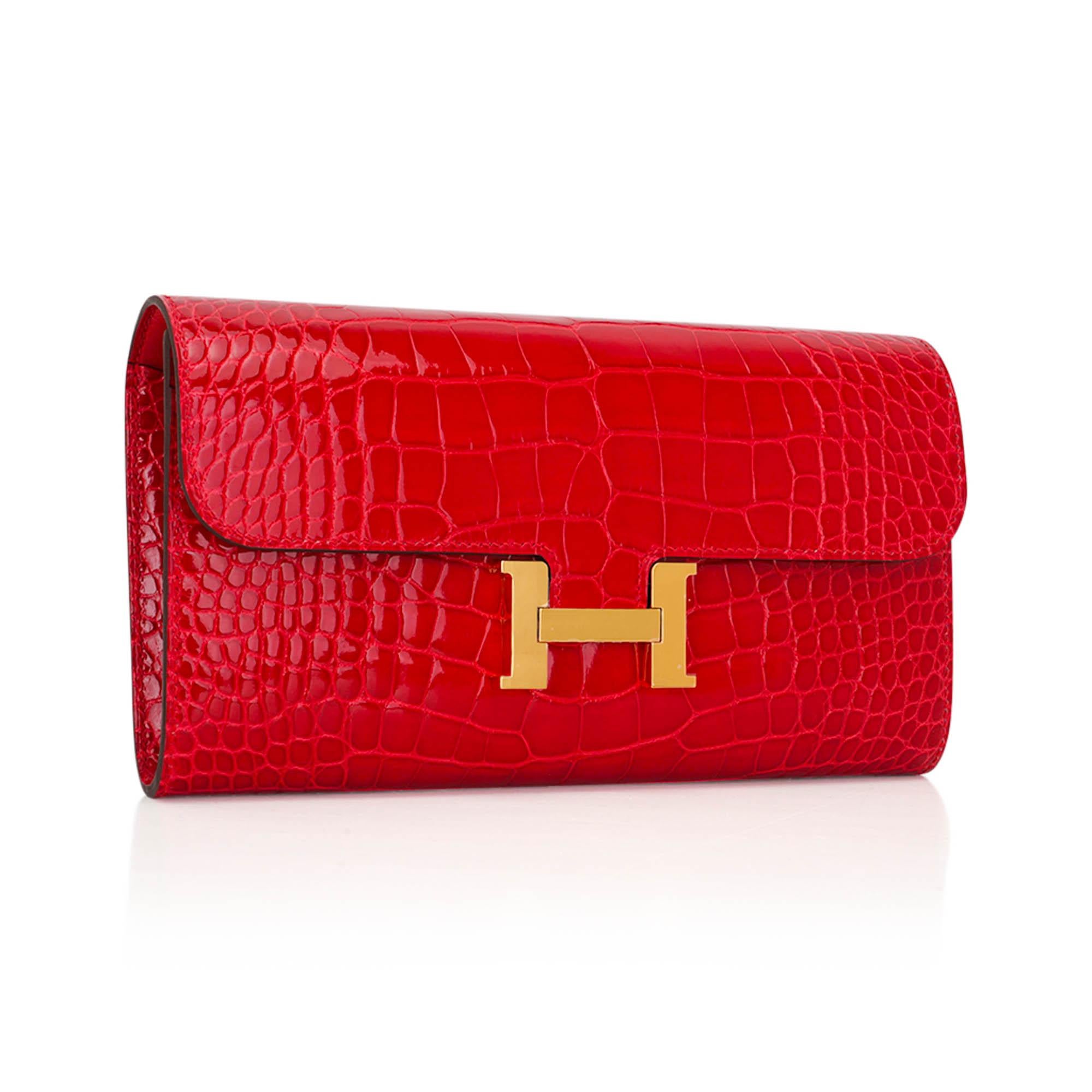 Mightychic offers an Hermes Constance Long To Go Wallet featured in coveted rare Braise Alligator.
This stunning Lipstick Red Braise Constance To Go is accentuated with Gold hardware.
Detachable crossbody shoulder strap converts this gorgeous