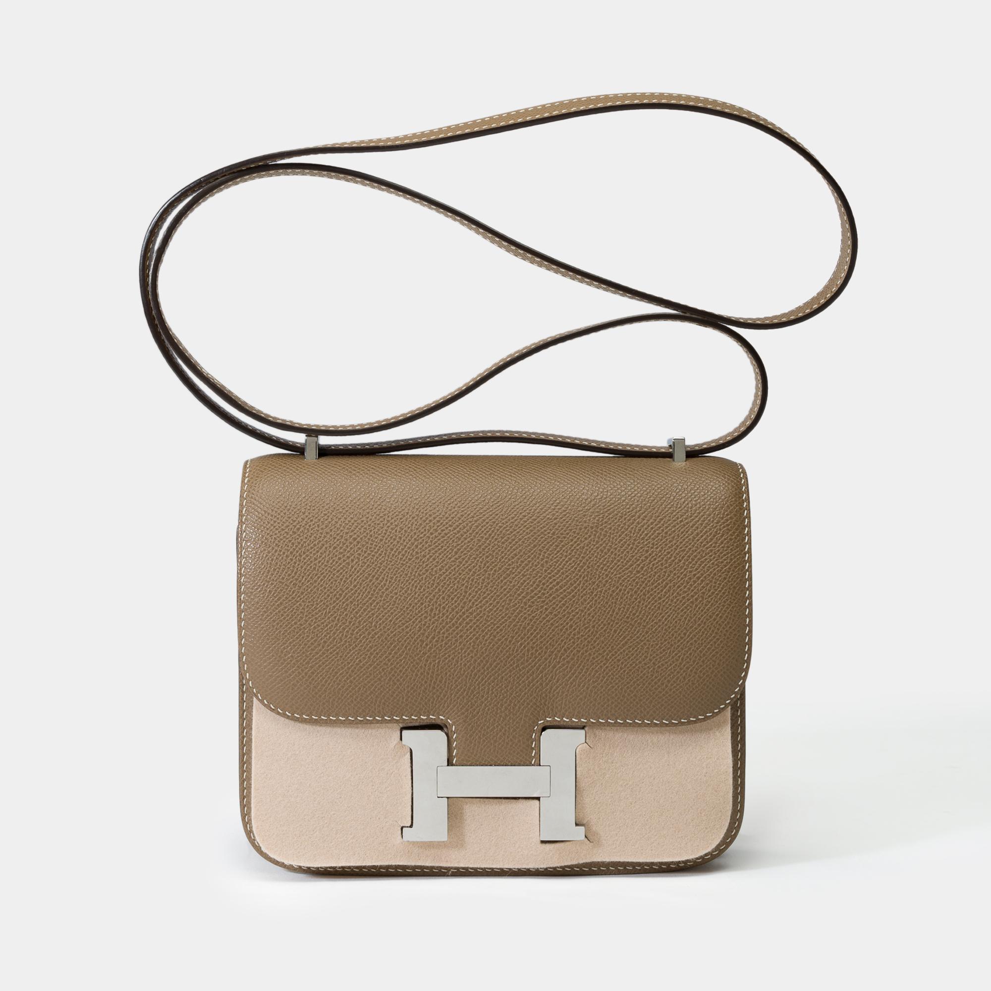 Beautiful​ ​Hermès​ ​Constance​ ​Mini​ ​18​ ​shoulder​ ​bag​ ​in​ ​etoupe​ ​epsom​ ​calf​ ​leather​ ​with​ ​white​ ​stitchings,​ ​palladium​ ​silver​ ​plated​ ​metal​ ​trim​ ​,​ ​a​ ​grey​ ​epsom​ ​leather​ ​shoulder​ ​strap​ ​allowing​ ​a​