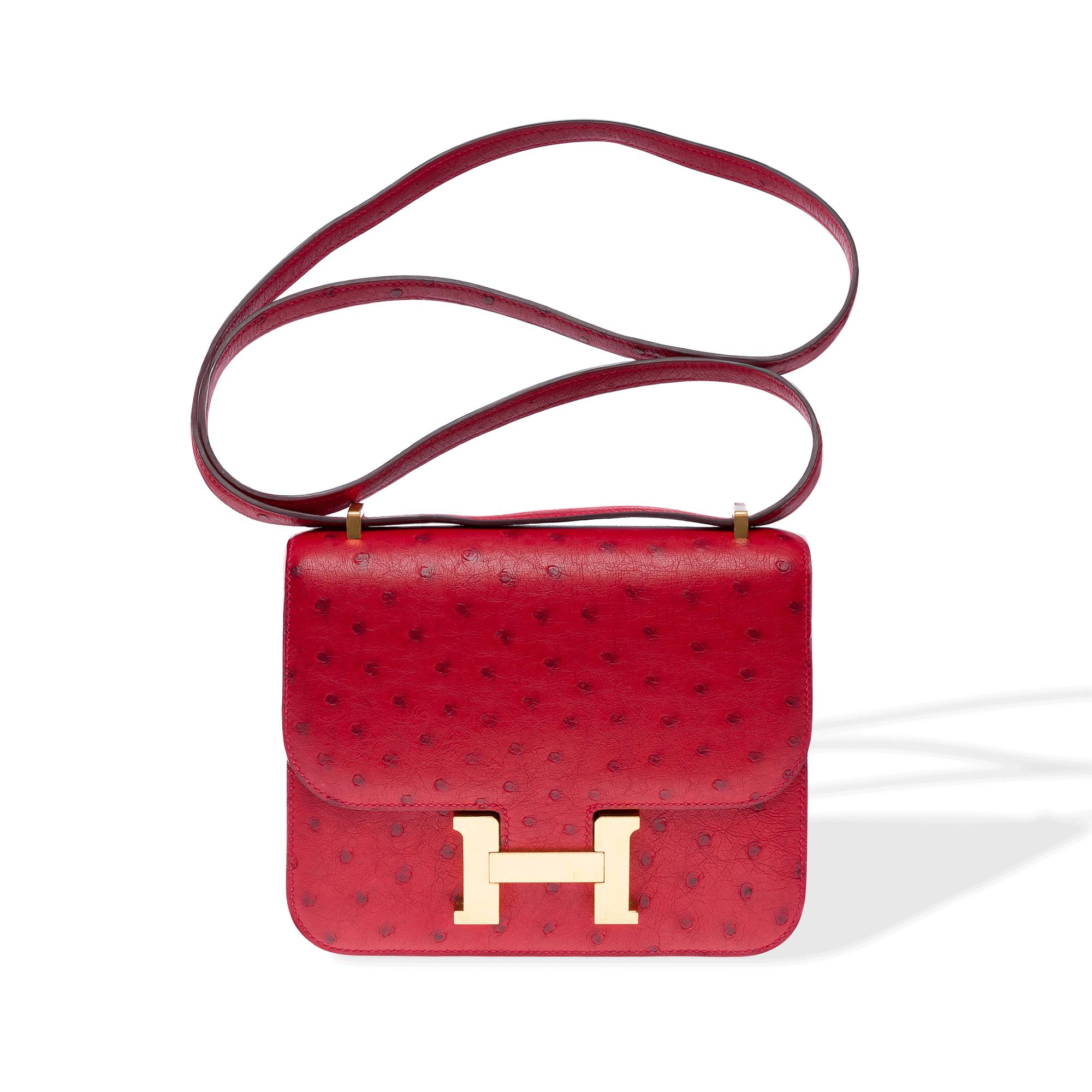 Extremely​ ​rare​ ​Hermes​ ​Mini​ ​Constance​ ​18​ ​cm​ ​shoulder​ ​bag​ ​in​ ​Rouge​ ​Vif​ ​ostrich​ ​leather,​ ​with​ ​gold​ ​metal​ ​trim.​ ​The​ ​handle​ ​can​ ​be​ ​transformed​ ​into​ ​red​ ​ostrich​ ​leather​ ​for​ ​shoulder​ ​or​ ​crossbody​