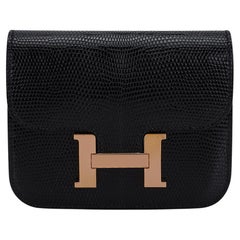 Hermès - Sac ceinture portefeuille « Constance Slim » en lézard noir et or rose avec détails dorés