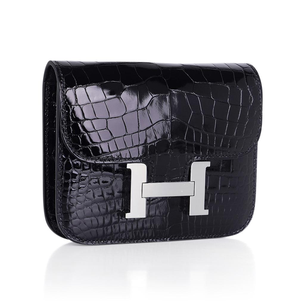 Mightychic offers an Hermes Constance Slim Wallet Belt bag featured in Black lisse Alligator.
This Hermes wallet is stunning with accentuated with crisp Palladium hardware,
The wallet includes a removable zipped change purse and has two (2) credit