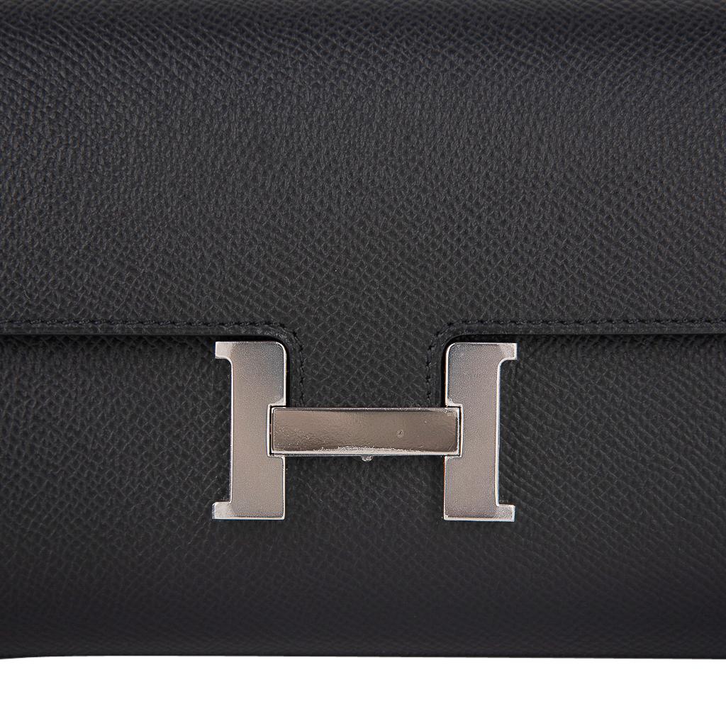 Mightychic offers a guaranteed authentic coveted Hermes Constance Long To Go featured in classic Black.
Accentuated with Palladium hardware and Epsom leather.
The consummate Wallet on a Chain!
Detachable strap allows you to carry the wallet / bag as