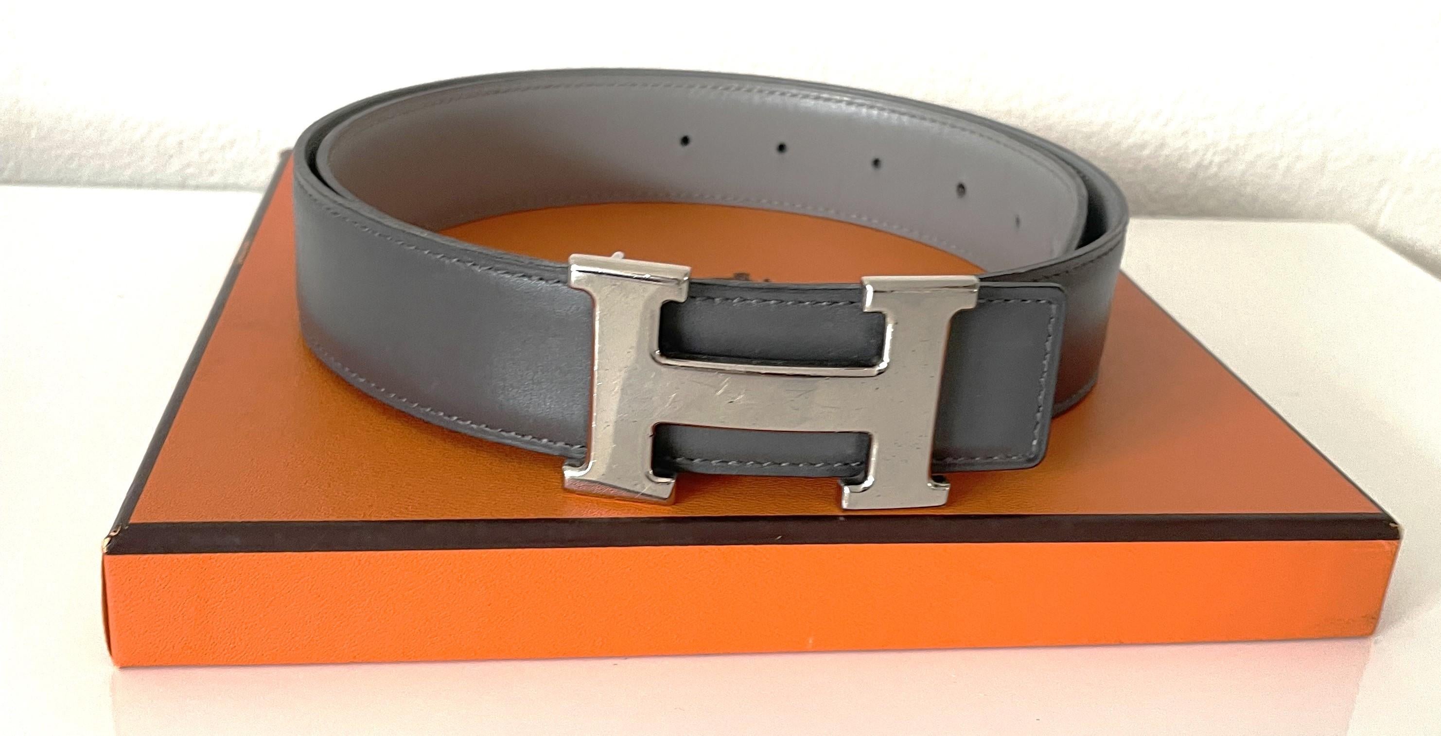 This collectors item SET of two leather authentic set of Hermes Constance belts (one buckle) is so beautiful. One leather belt in dark grey and light grey with an 1998 B square marking and 6 holes. It is in good condition. 
The other authentic