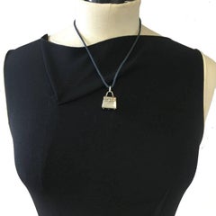 HERMES Cord necklace and 'Kelly Bag' Amulet Pendant in Sterling Silver