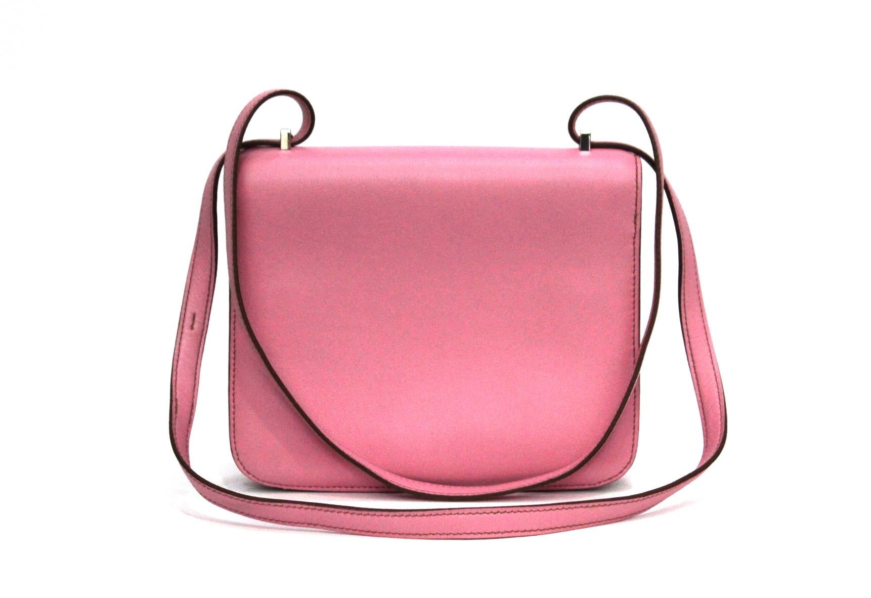 This Hermes Constance Mini bag is made from smooth Swift leather and featured in color Rose Azeala, a coveted shade of Hermes pink. Measuring 18cm and accented by palladium hardware