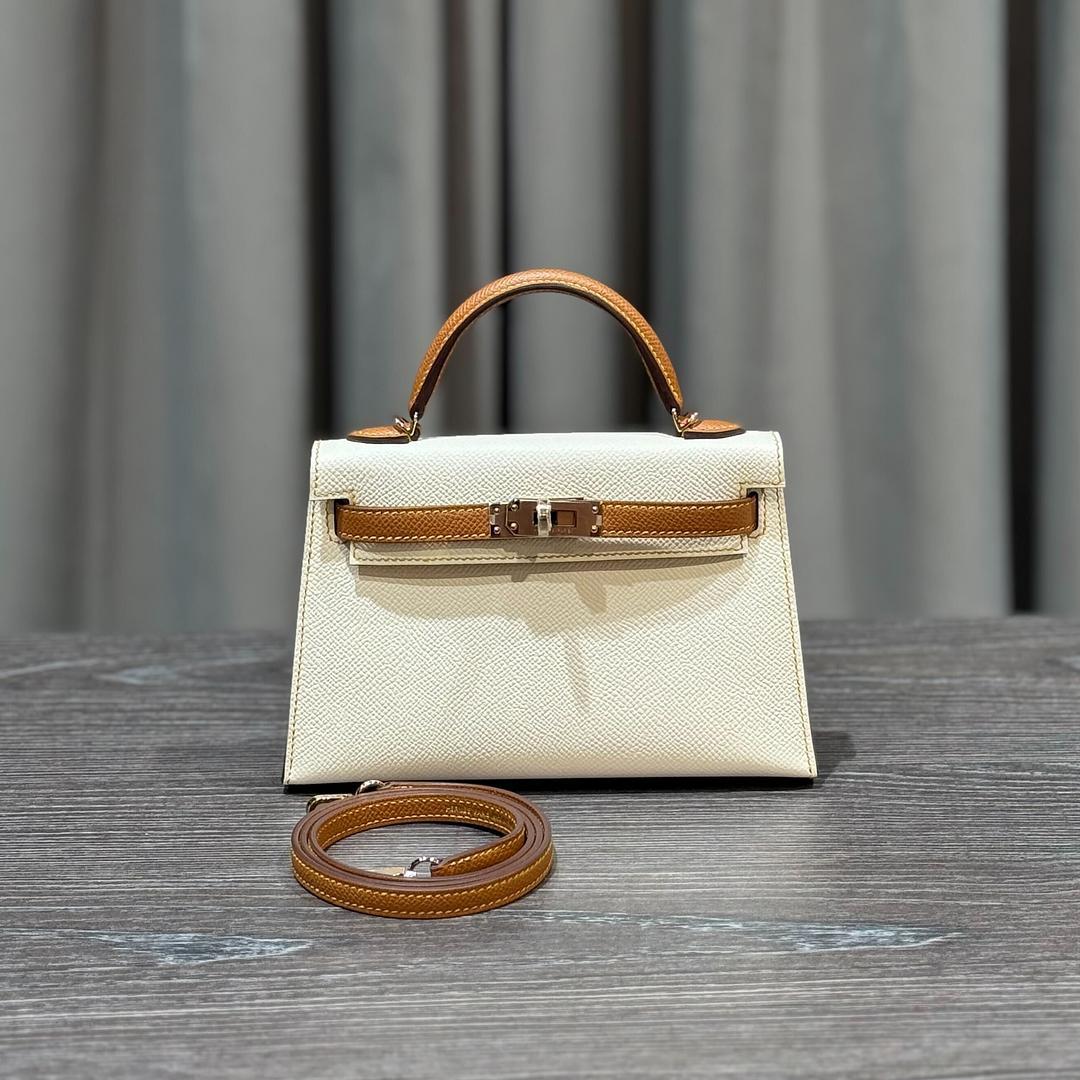 Jewels Aficionado offers the Hermès Mini Kelly 20 Sellier, a rare Special Order (HSS) in Craie and Gold Epsom leather. The crisp off-white Craie paired with warm Gold accents and contrast stitching creates a timeless, elegant look. Crafted in