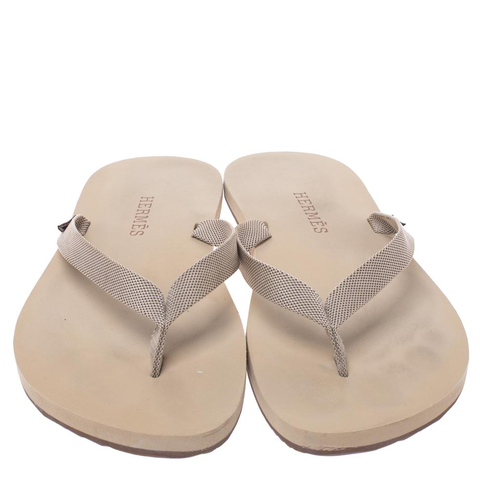 These Hermes Isolella flip flops are designed using technical fabric straps and set on a rubber base for a comfortable experience. The flip flops are made for days at home and for days at the beach.

Includes: Original Dustbag