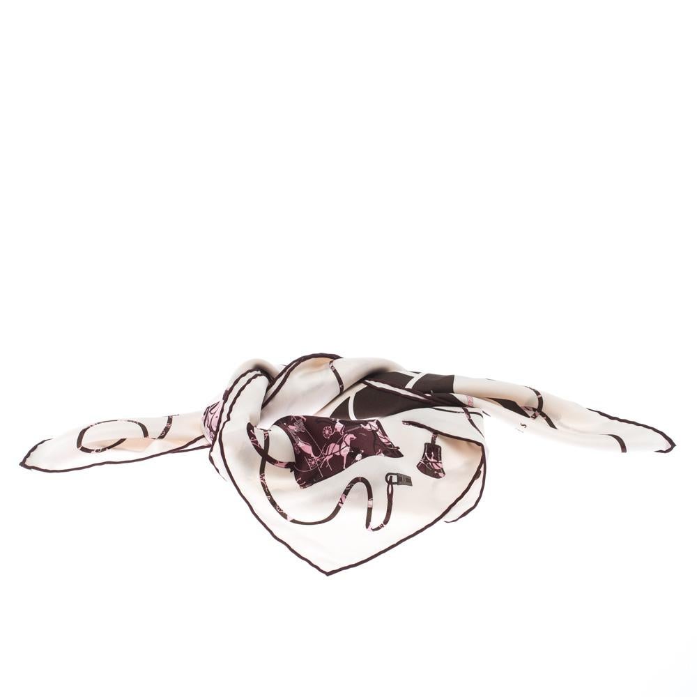 This silk Kelly scarf by Hermes will give you a chic look. Combining the lovely pink-brown Kelly print over a cream background, it also comes with 'Hermes Paris' printed over it. The scarf can be worn as a neck scarf, or placed as a bow on your